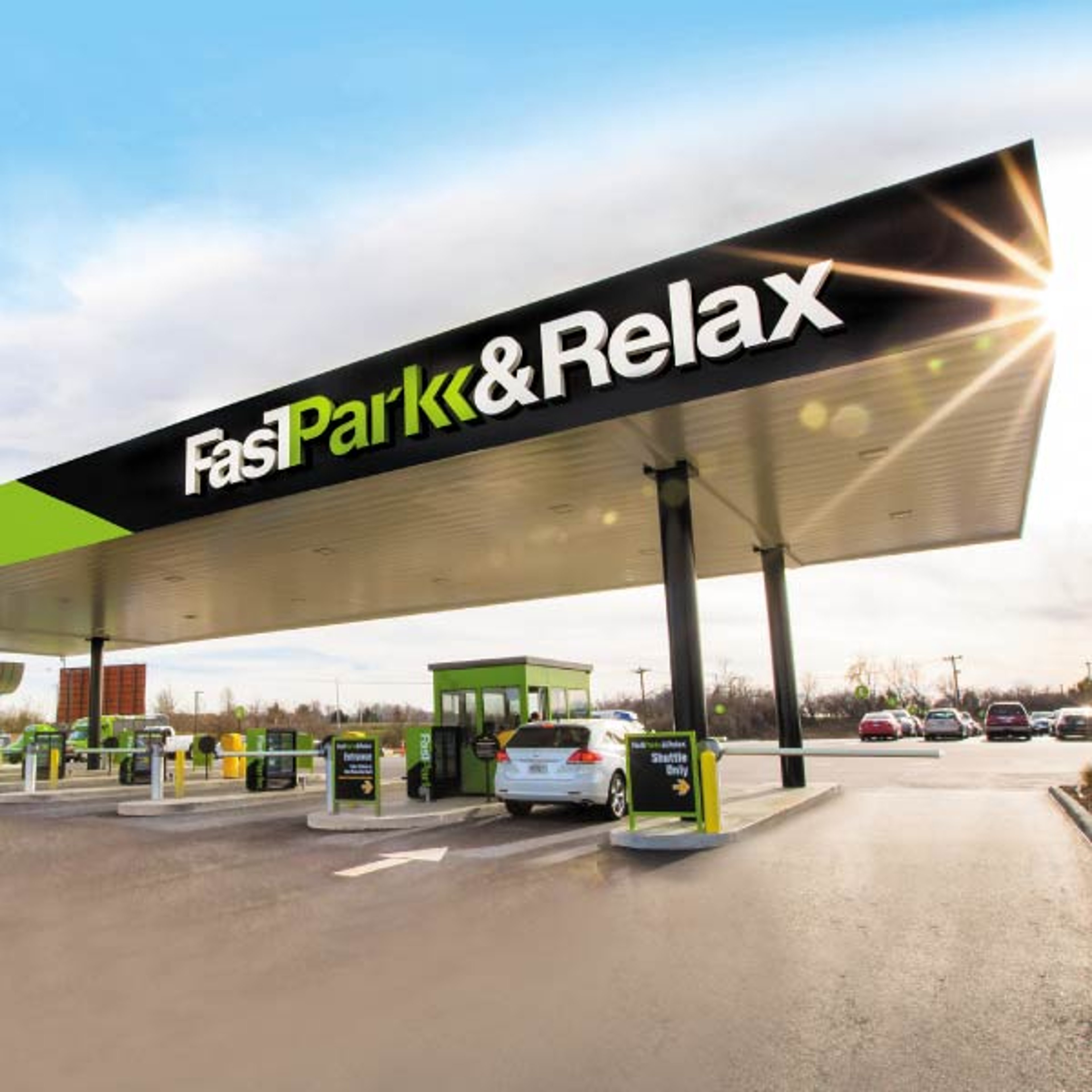 A white SUV parked at a Fast Park pump with the sun glistening in the background 