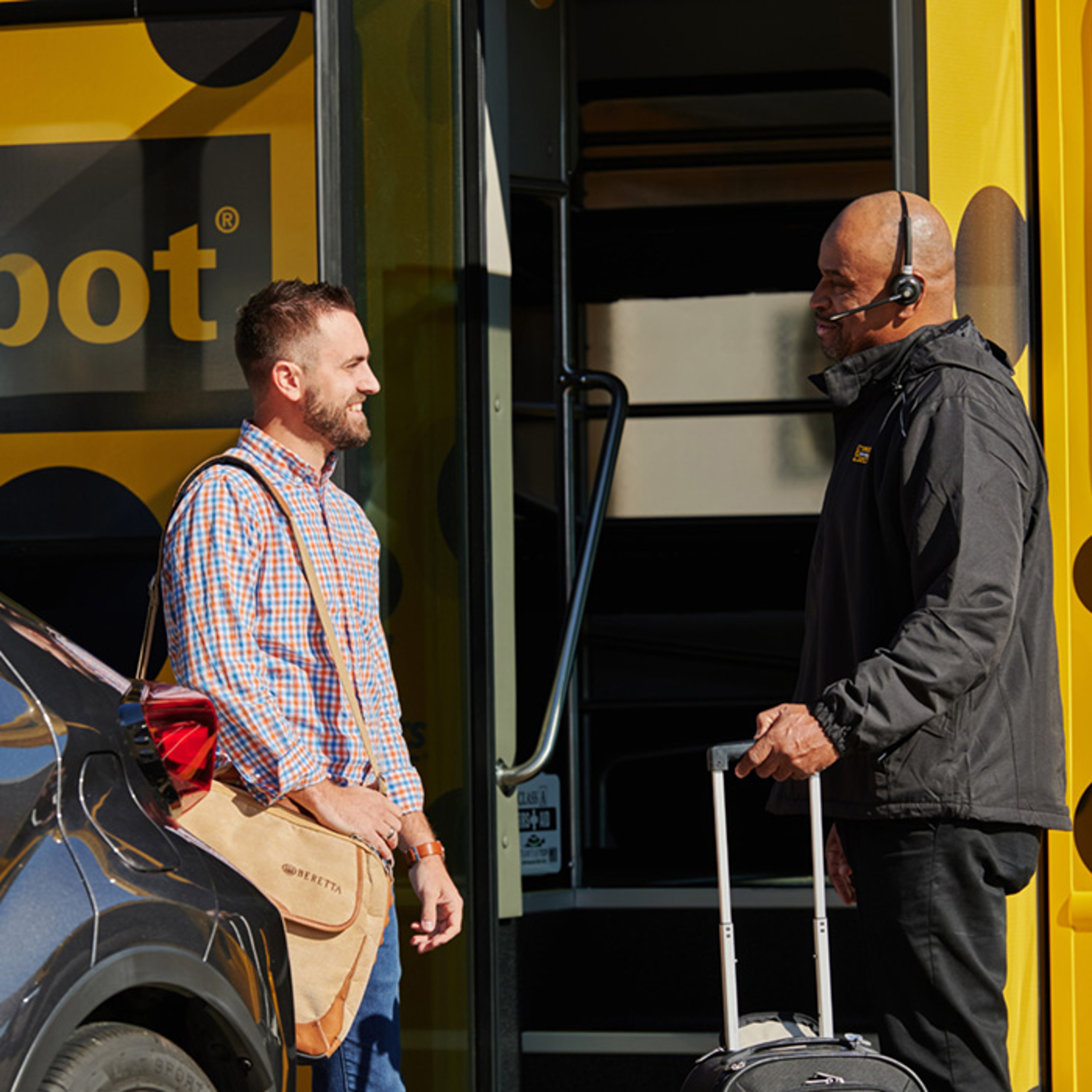 Parking Spot attendant helping customer as he boards shuttle bus