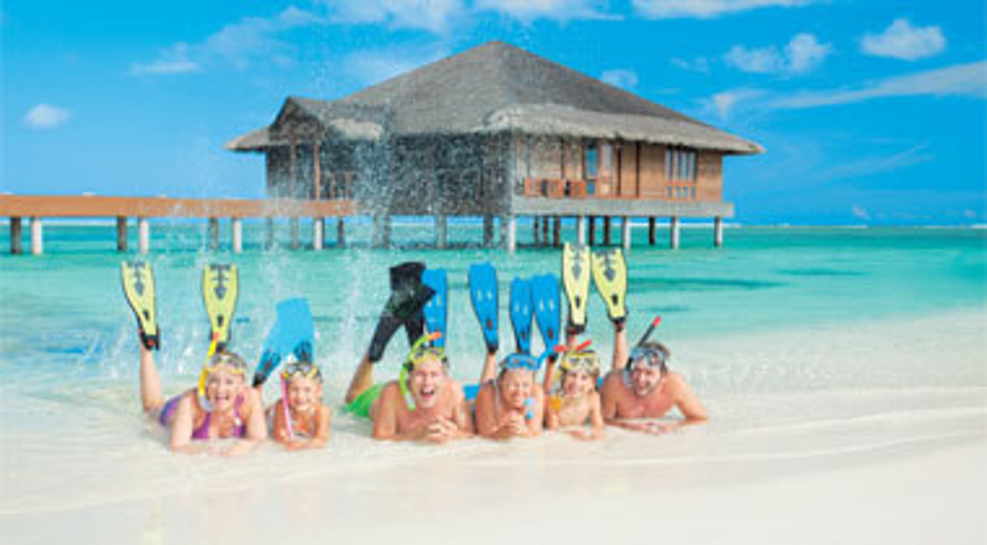 Large family wearing snorkel gear on the beach