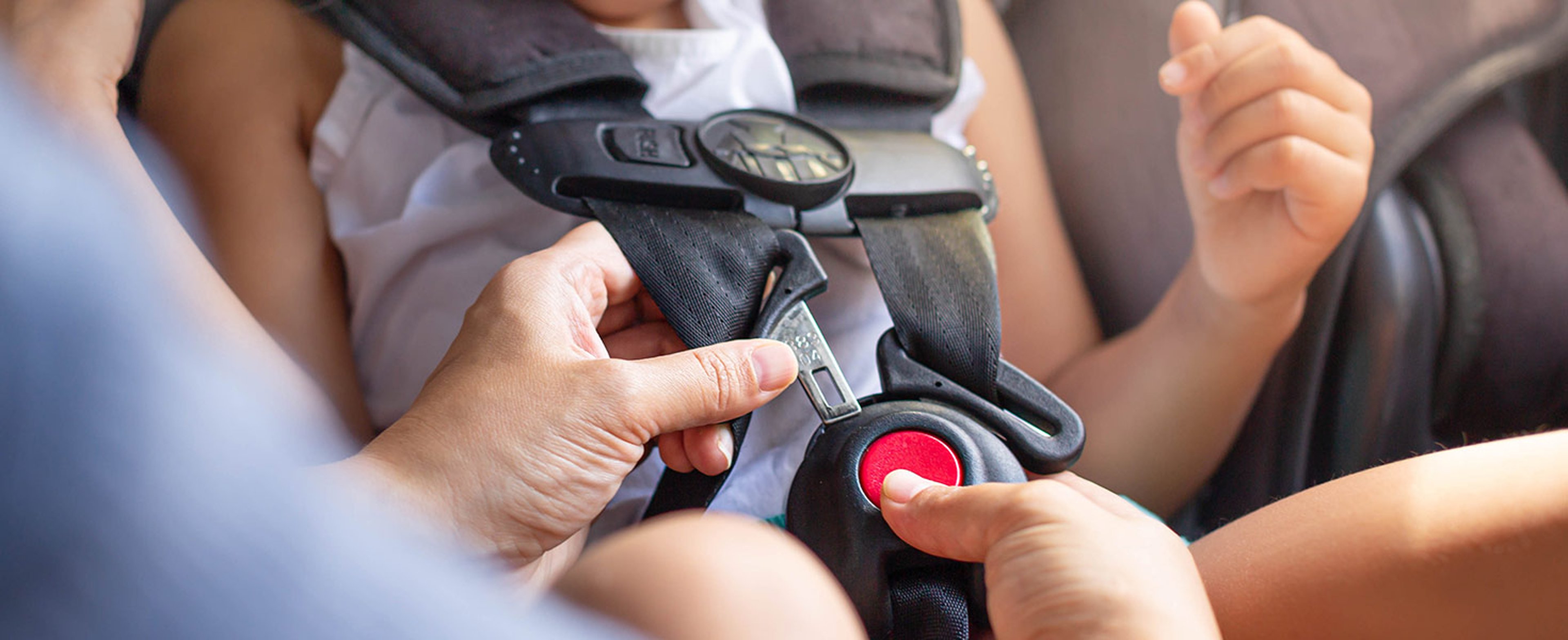 Child getting buckled into passenger seat