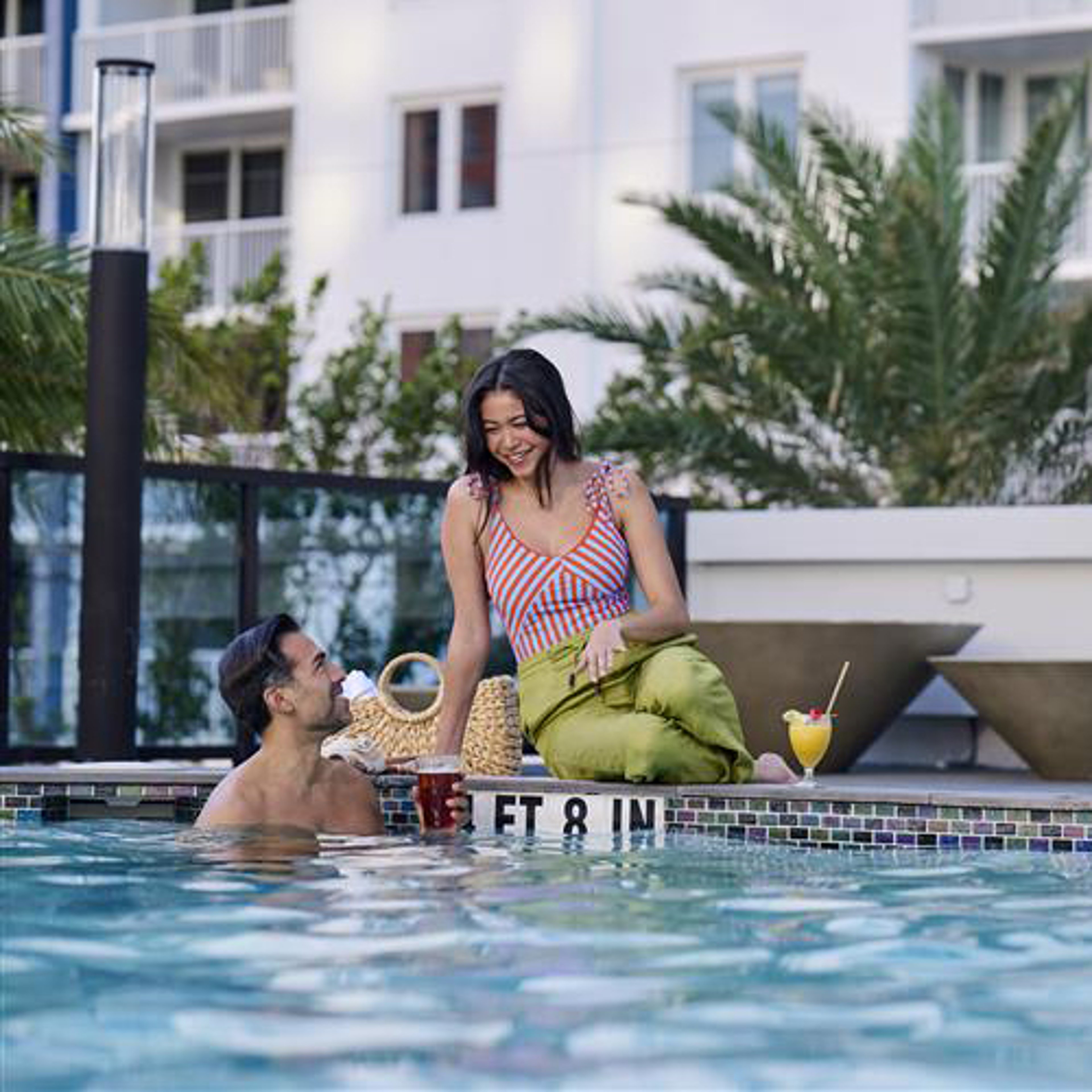 Couple in pool at island resort hotel
