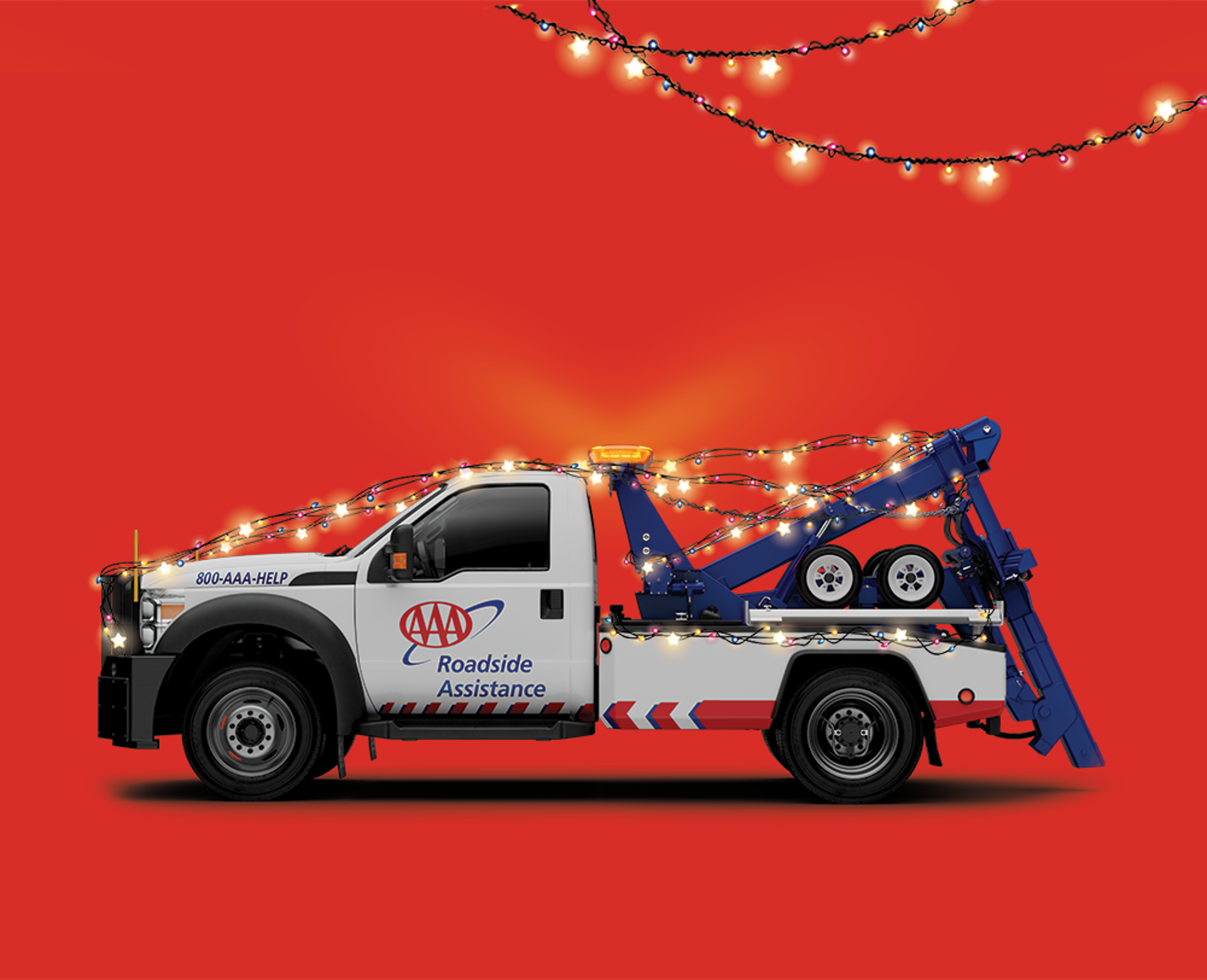 AAA Tow Truck with colored Christmas tree lights draped over it