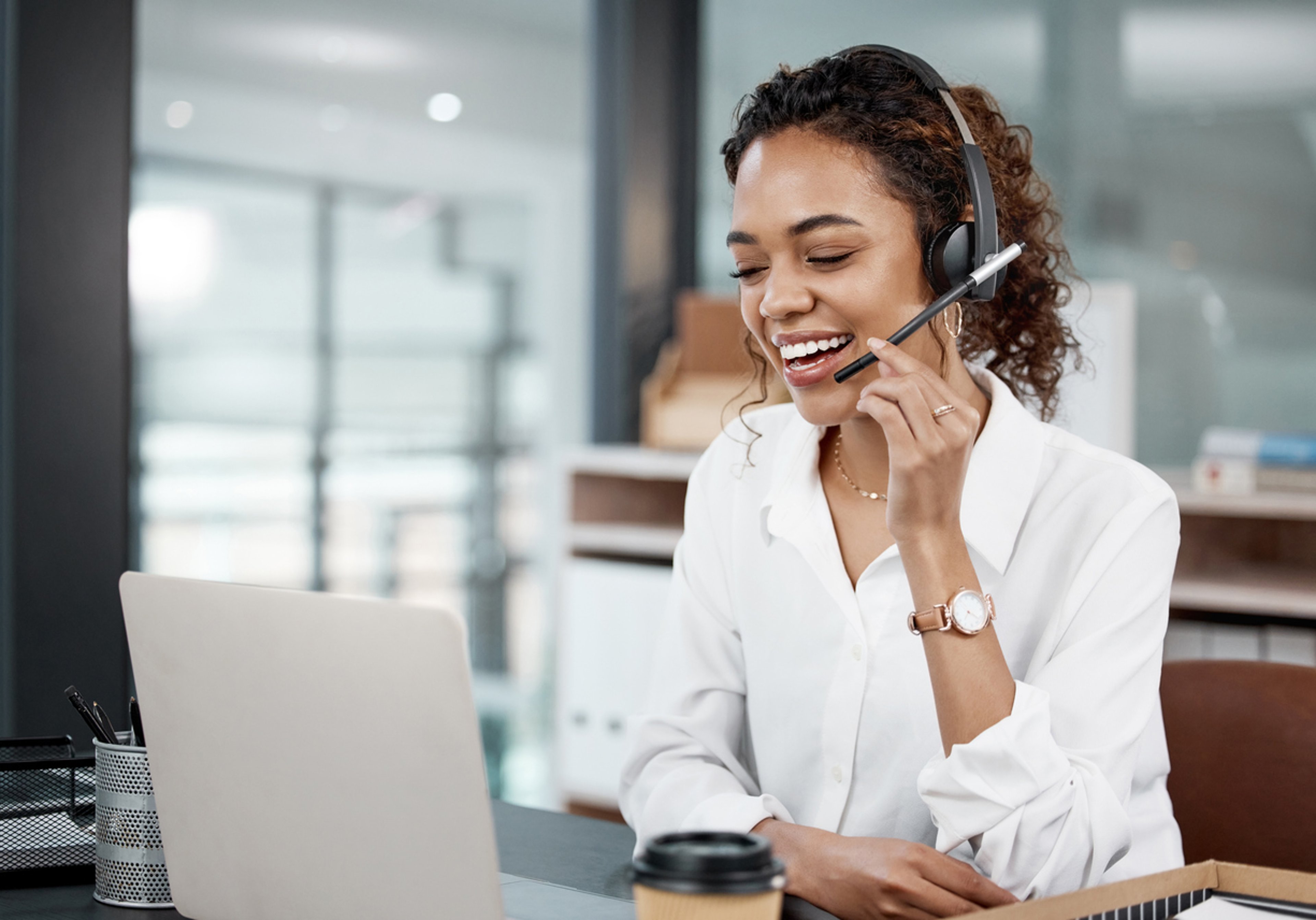 young female call center agent working at her desk in the office