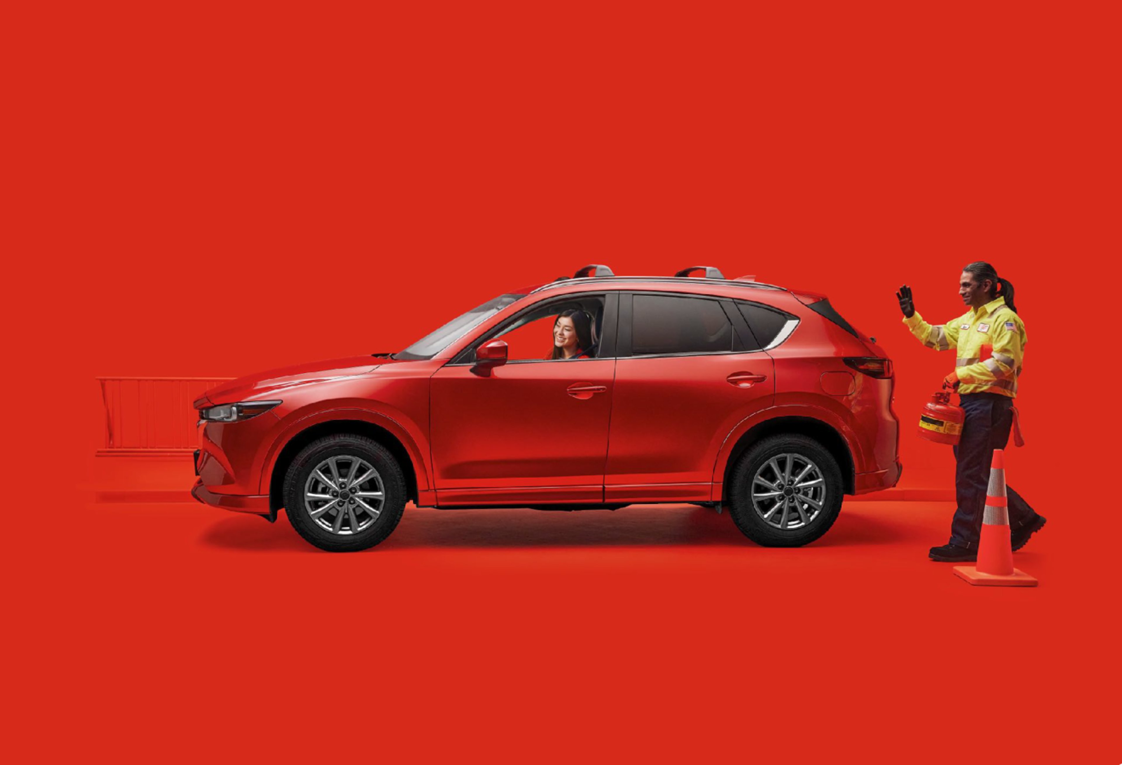 AAA Roadside technician approaching SUV with happy occupant 