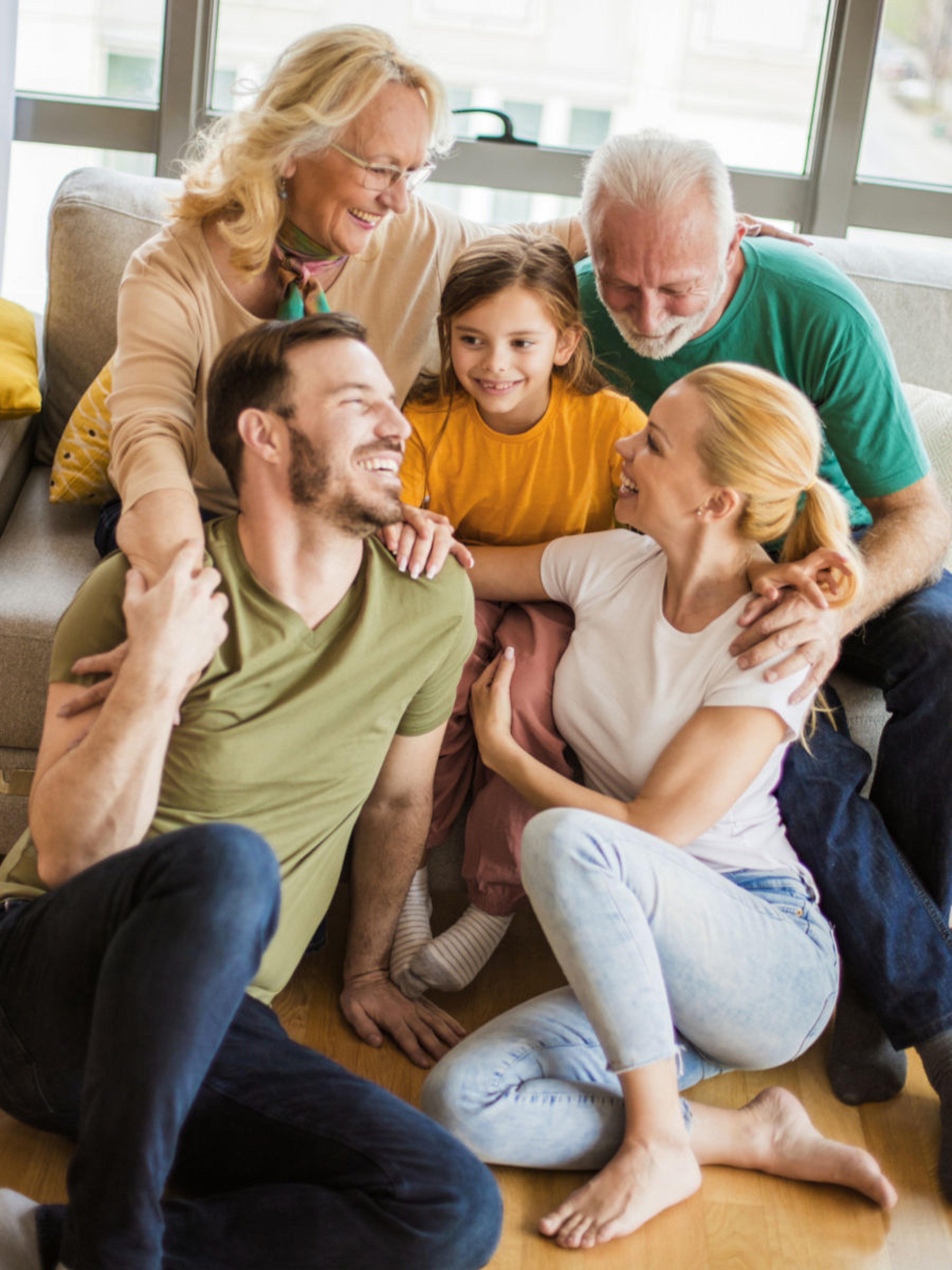 Three generations of family relaxing together at home