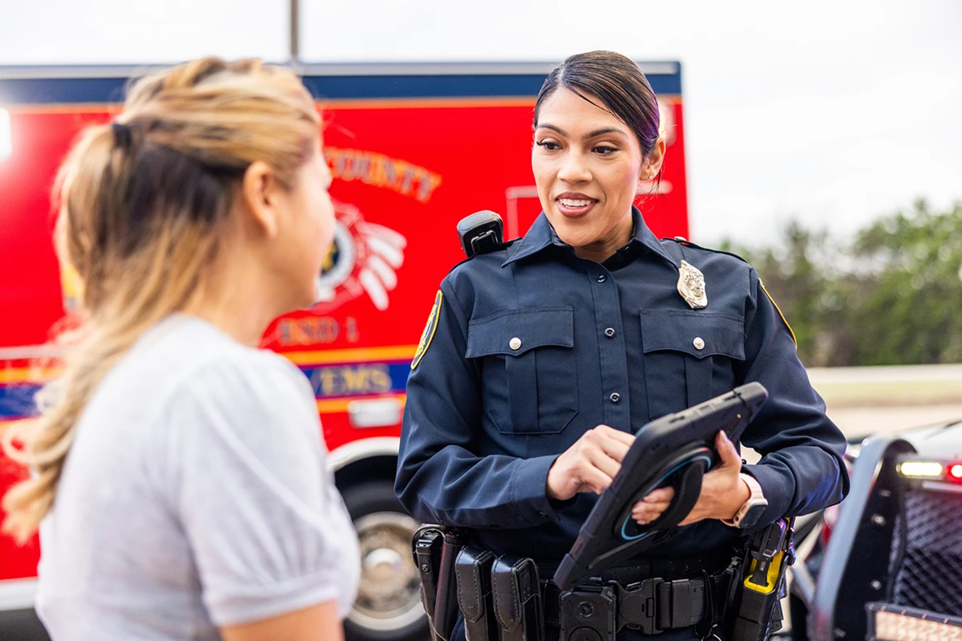 Police officer speaking to woman on the side of the road