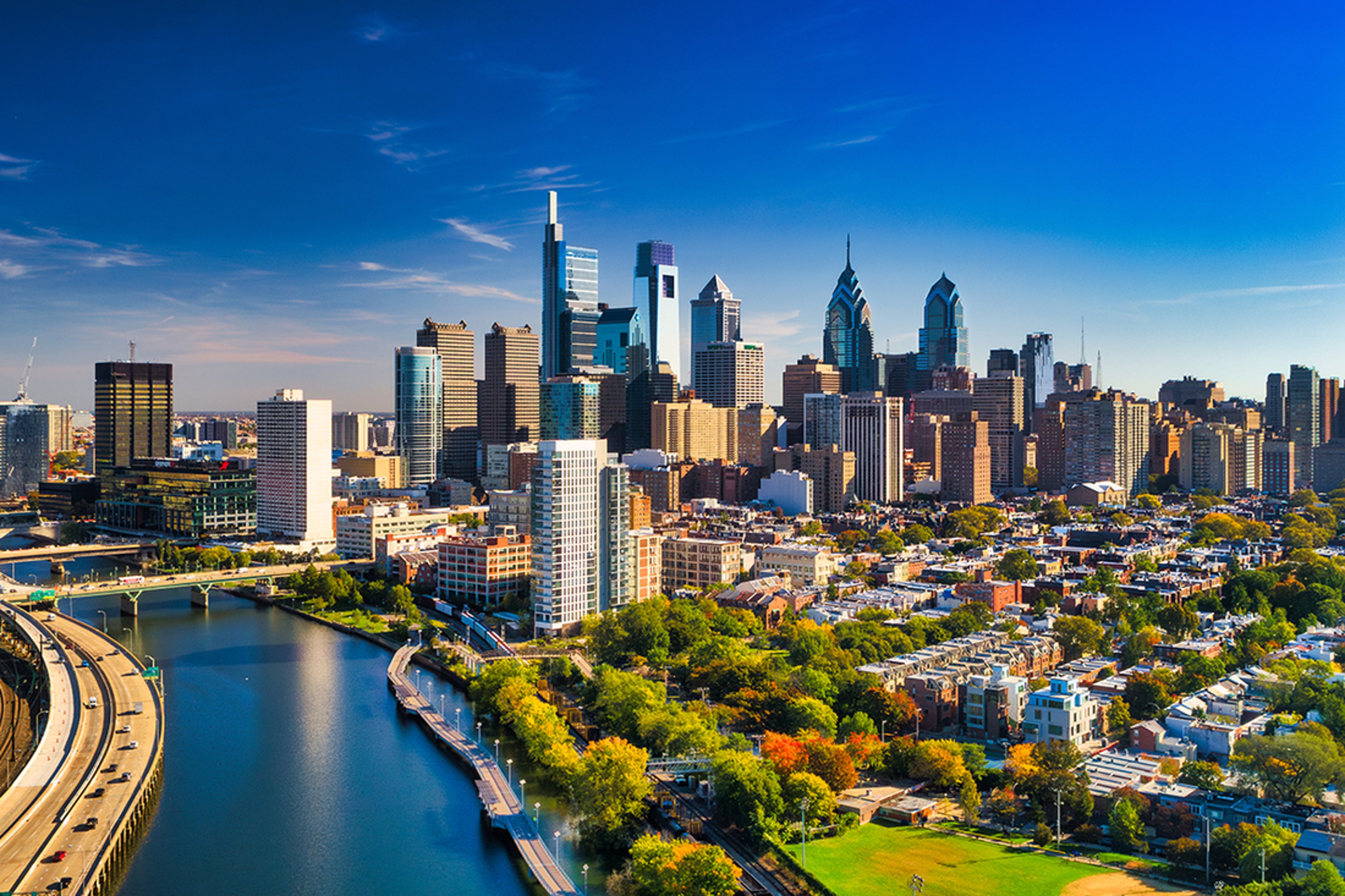 Philadelphia skyline beside the river under a clear blue sky