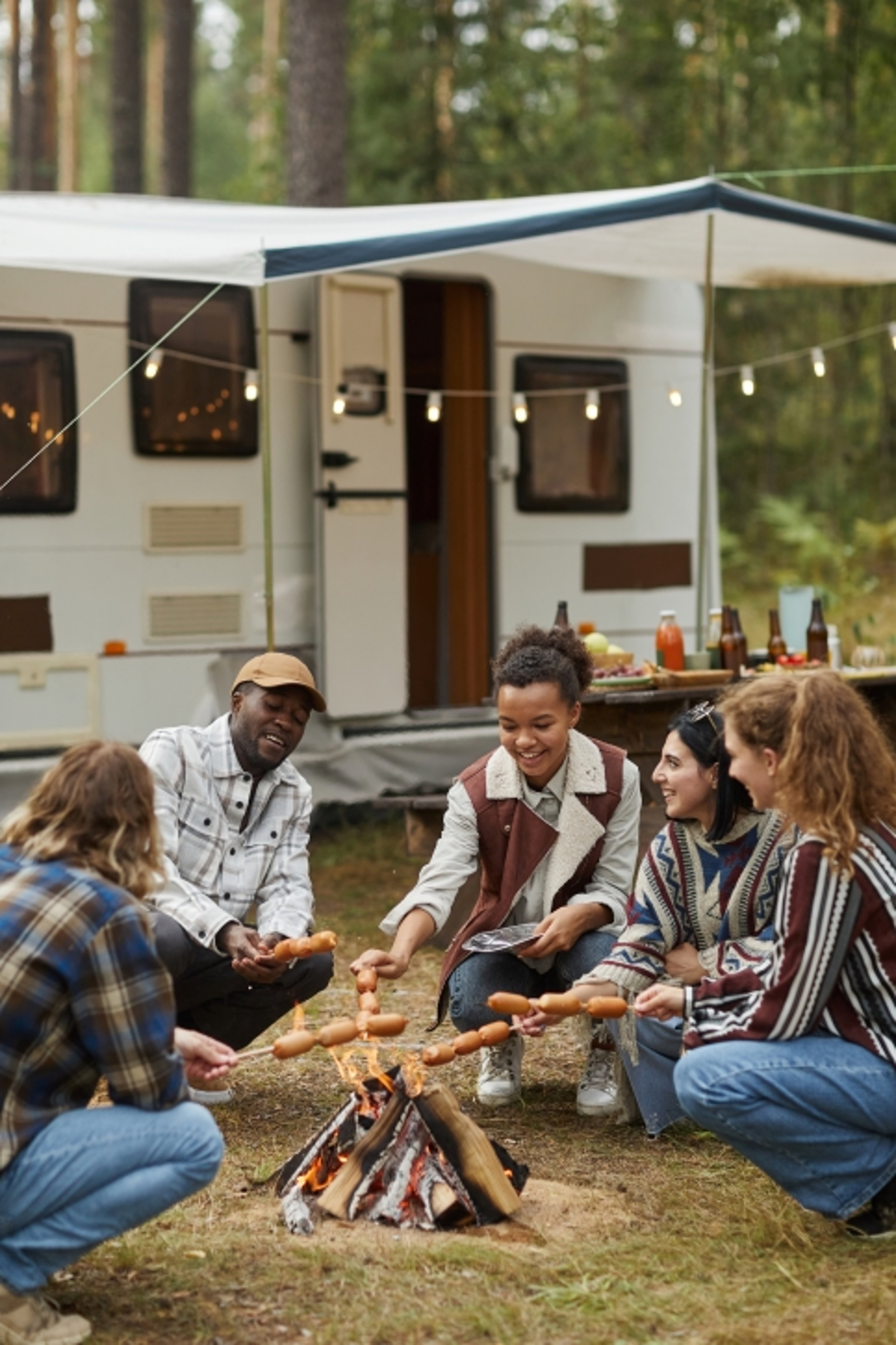 Specialty lines insurance family in front of RV with campfire