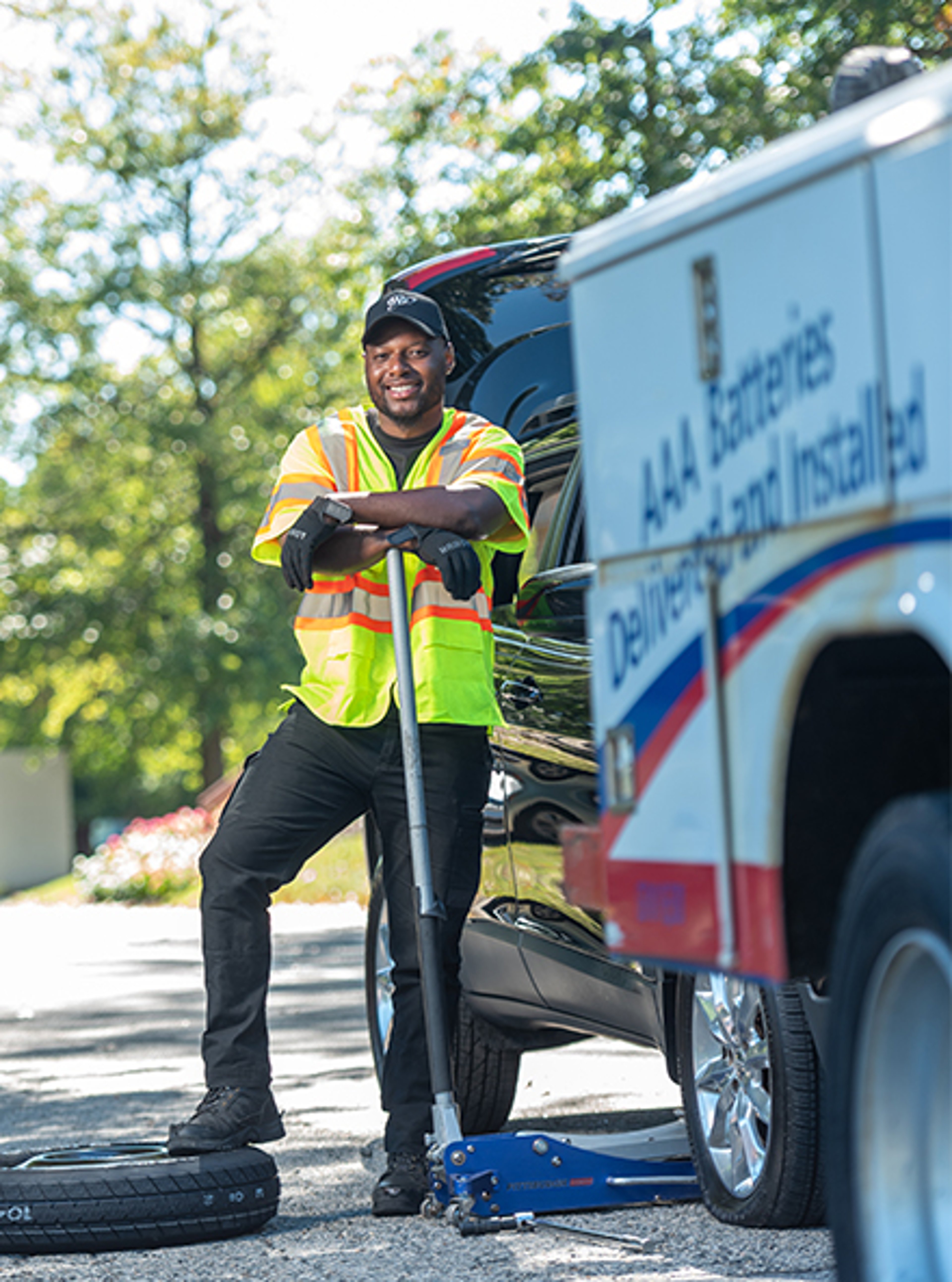 AAA road side driver changing a flat tire