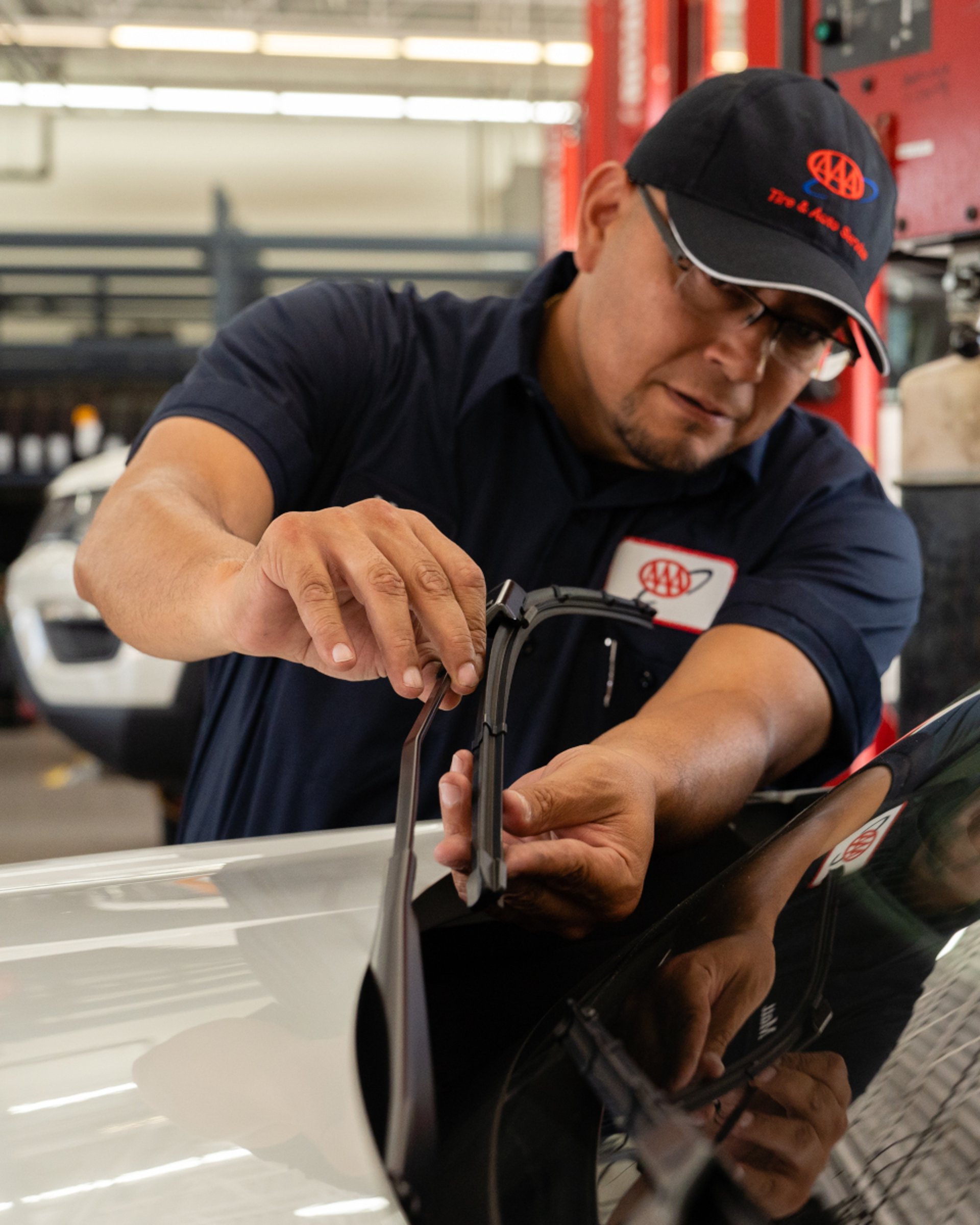 AAA auto technician working on vehicle at car care tire and auto service location