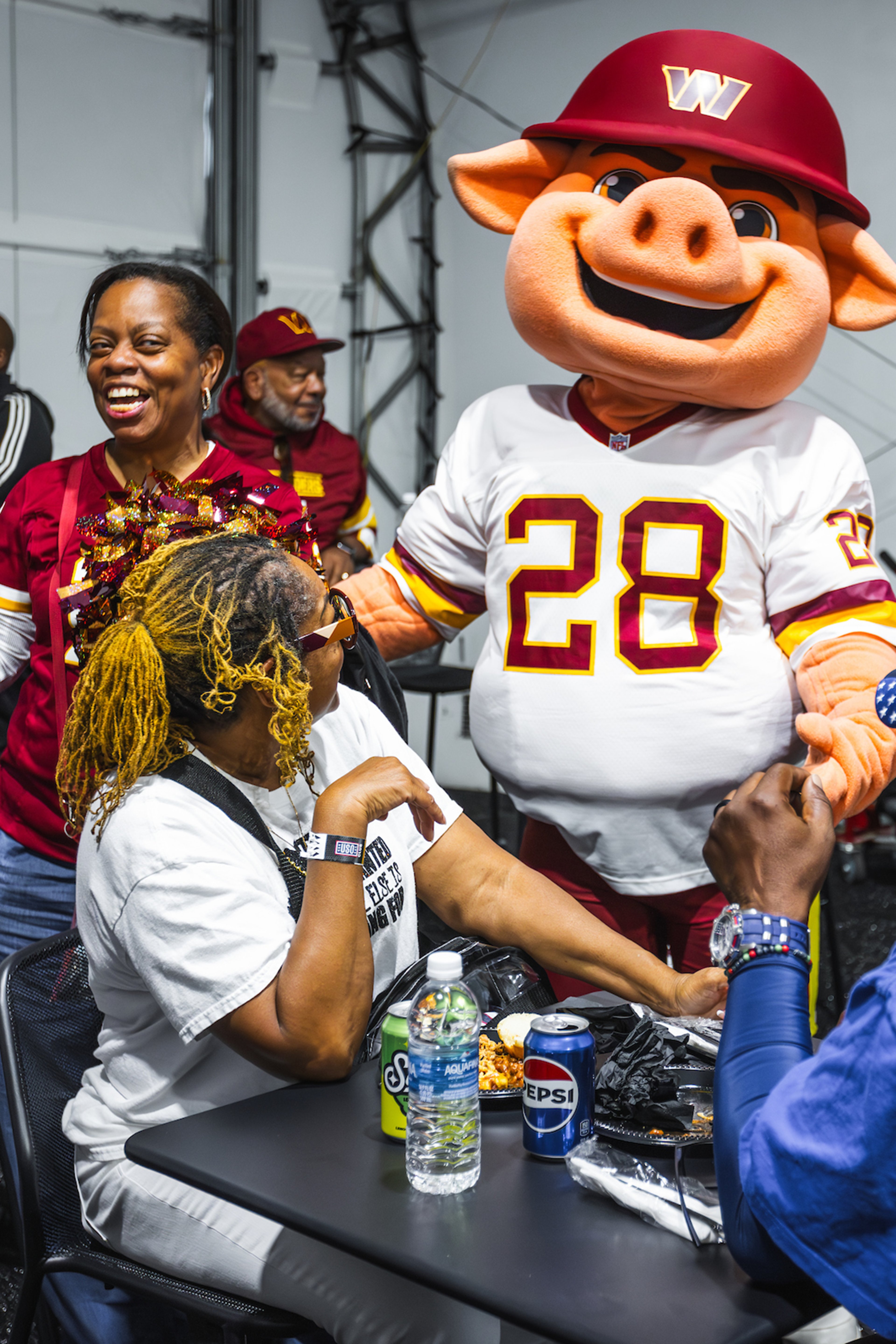 Washington Commanders mascot hanging out with Commanders fans