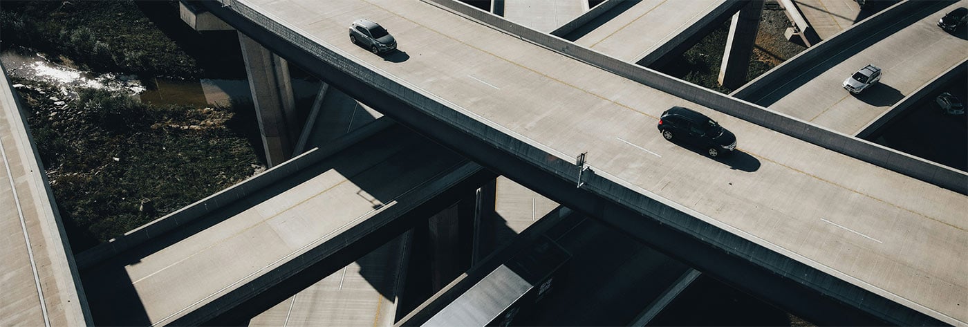 Aerial view of a highway interchange with multiple intersecting overpasses and cars traveling on them