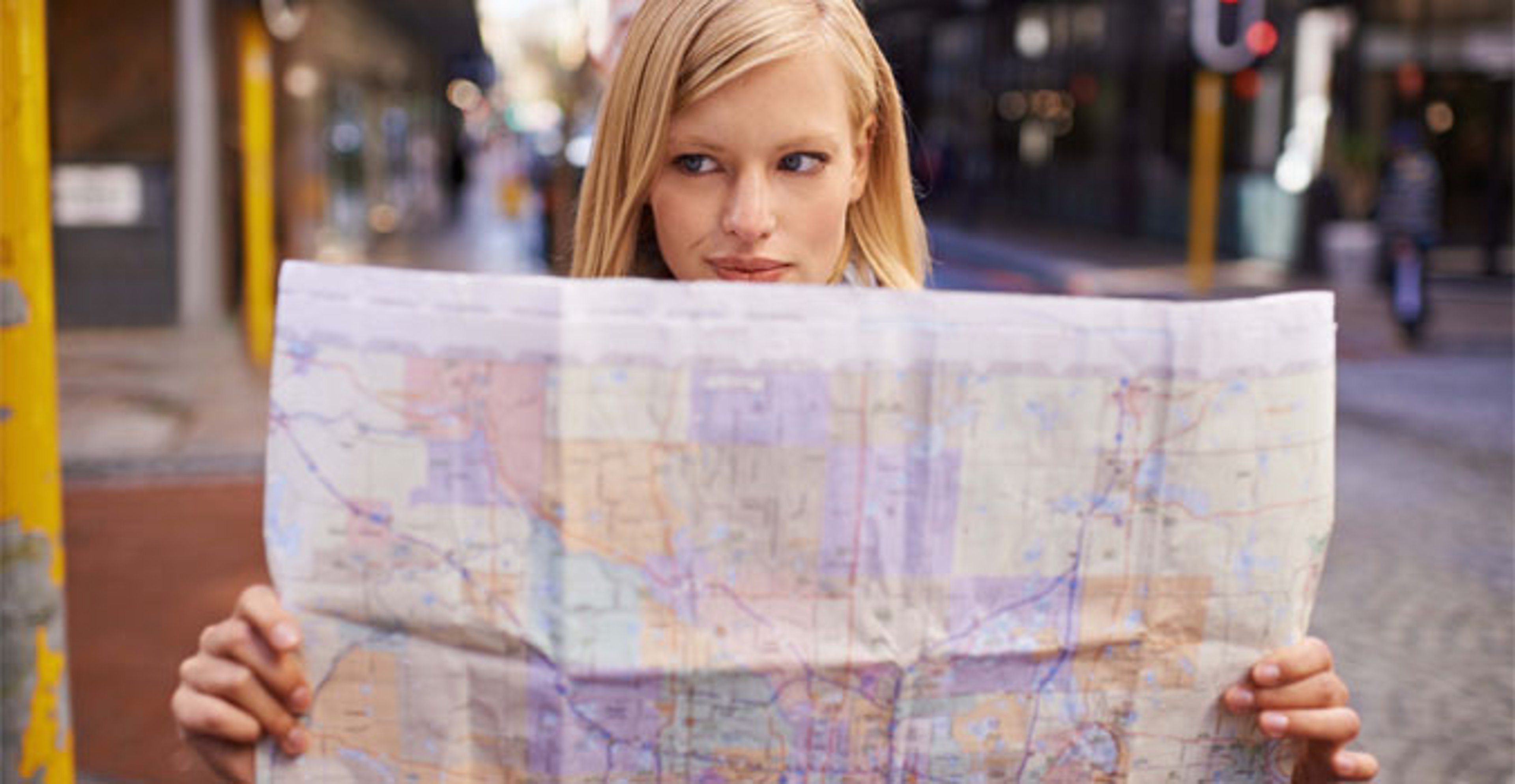 Woman outside looking at map