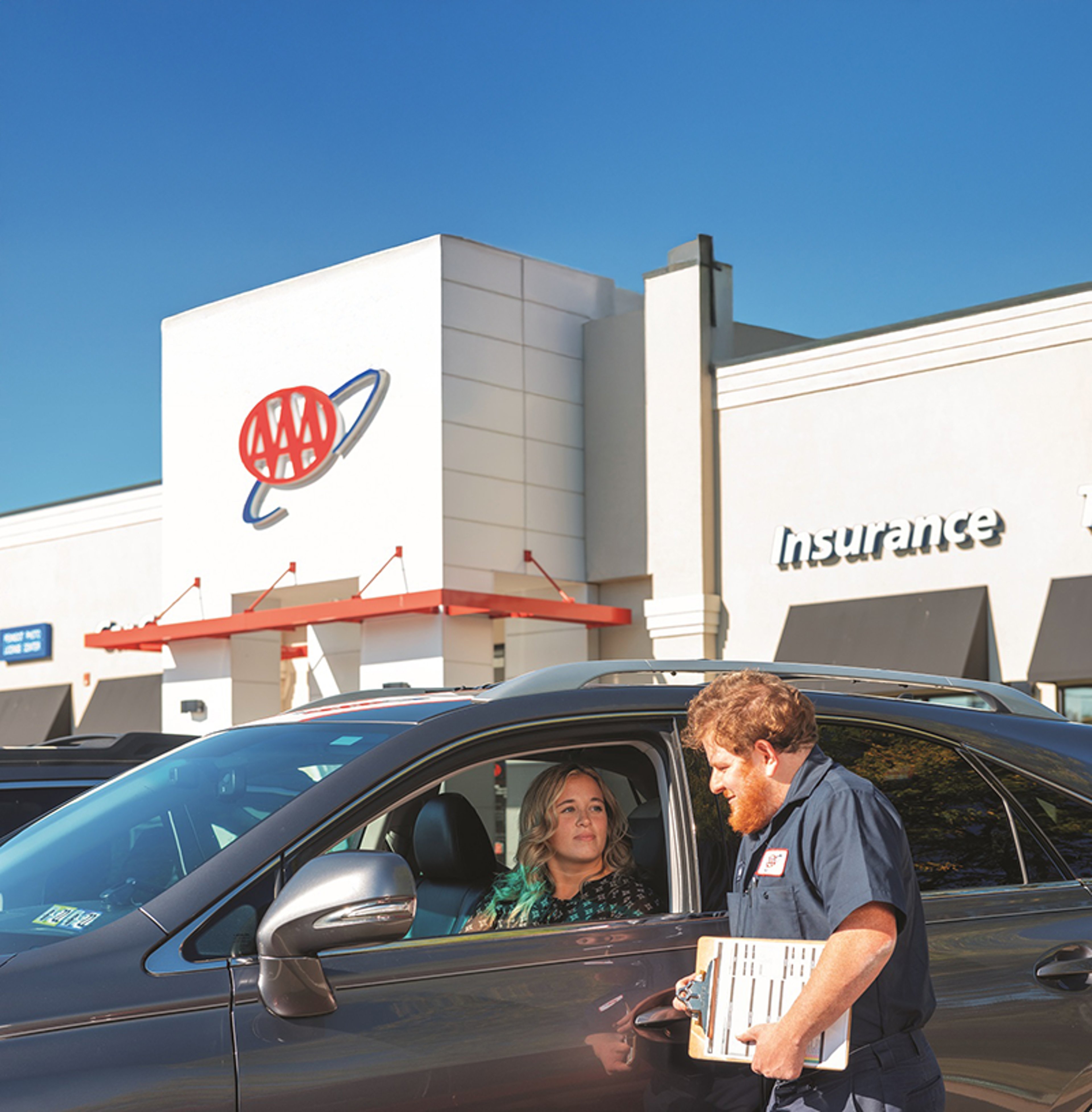 AAA Tire & Auto technician speaking to satisfied customer