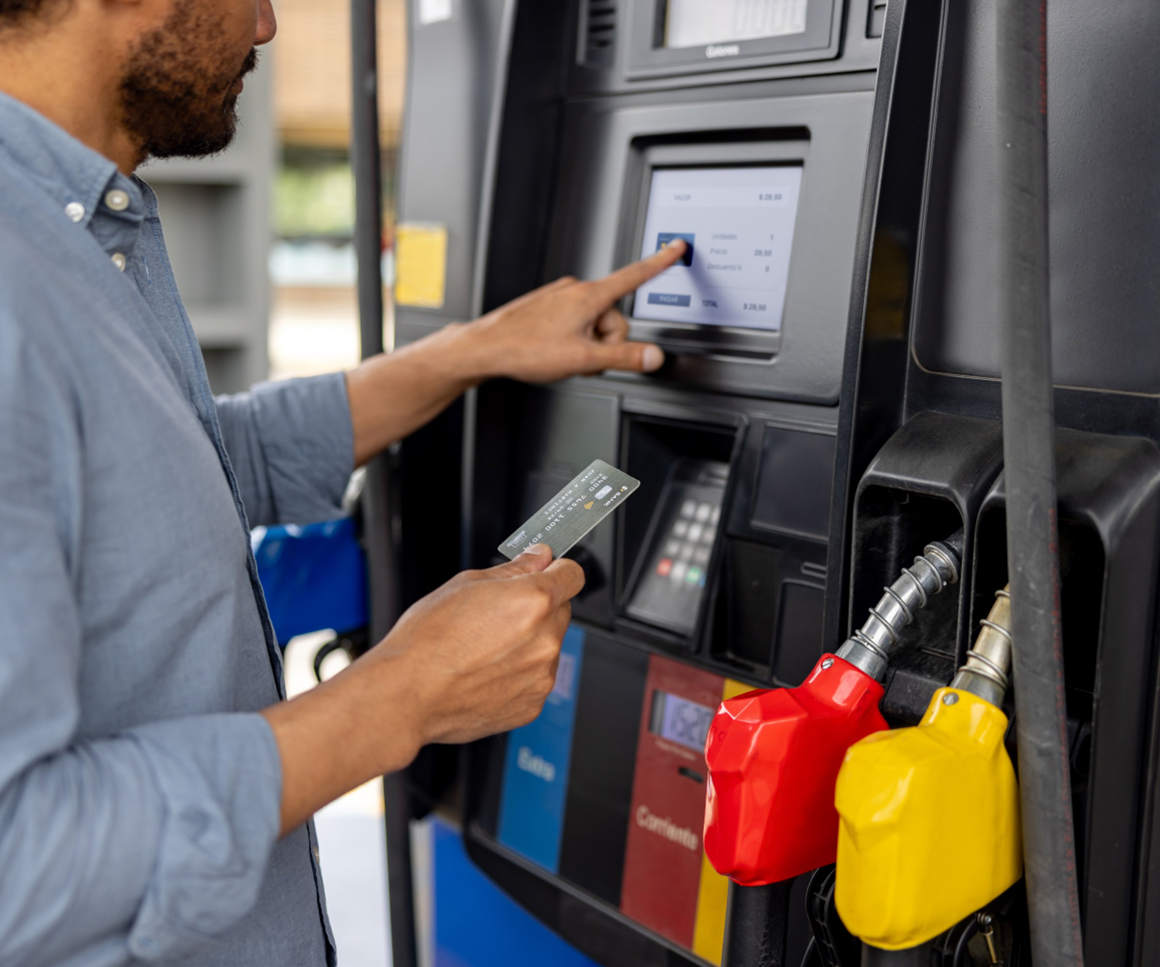 A man paying for gas with a credit card at the gas pump