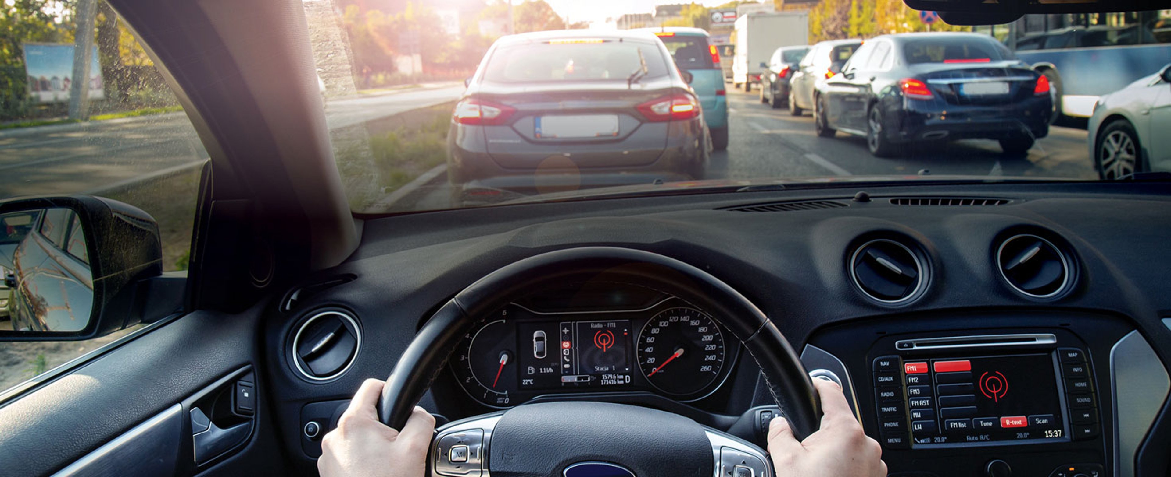 Driver with hands on the wheel stuck in traffic