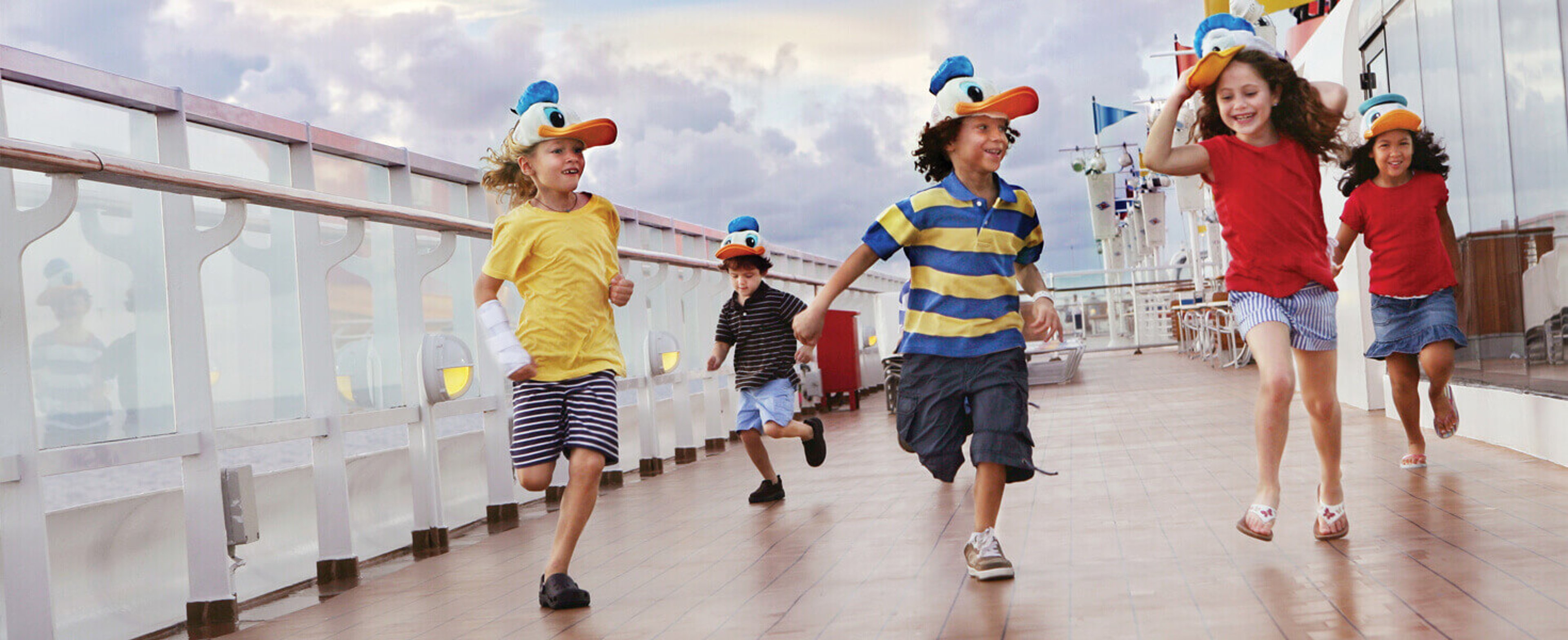 Kids playing and running along the deck of a disney cruise ship