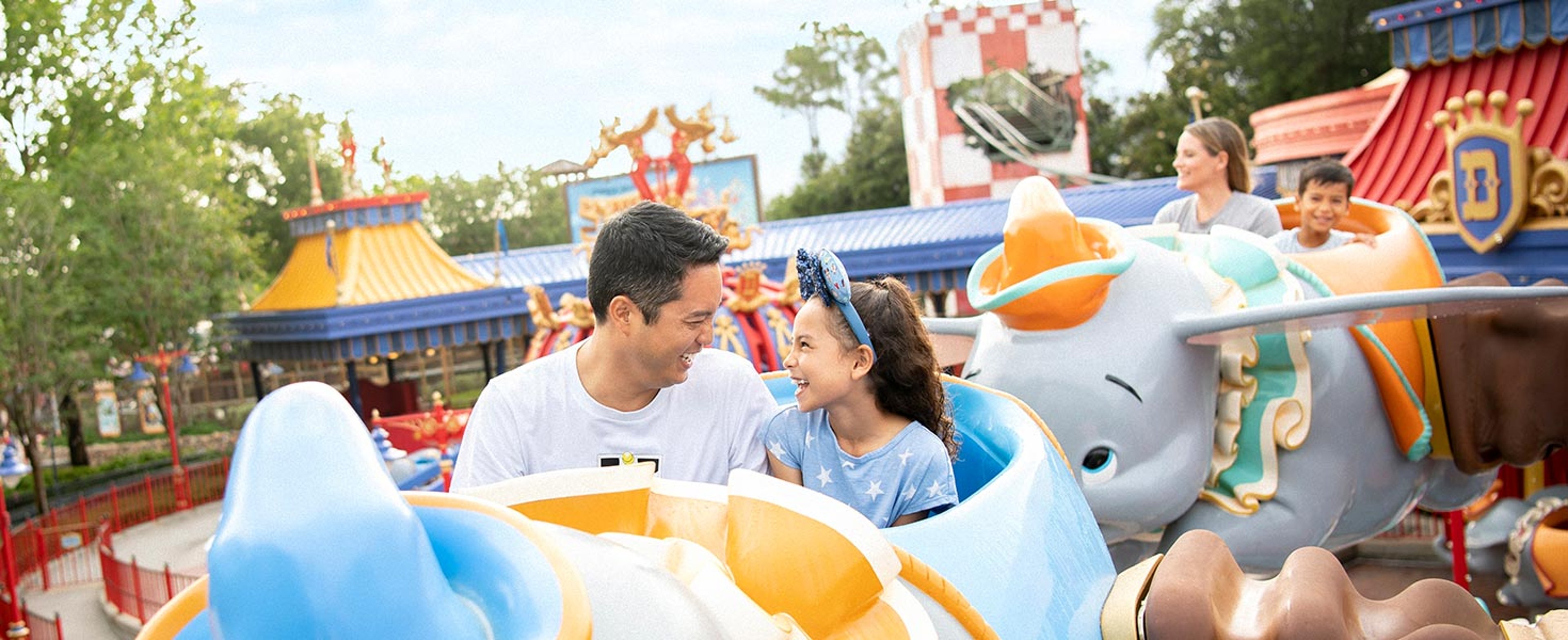 Disneyland Dumbo Ride Father and daughter smiling on Dumbo ride in Disneyland