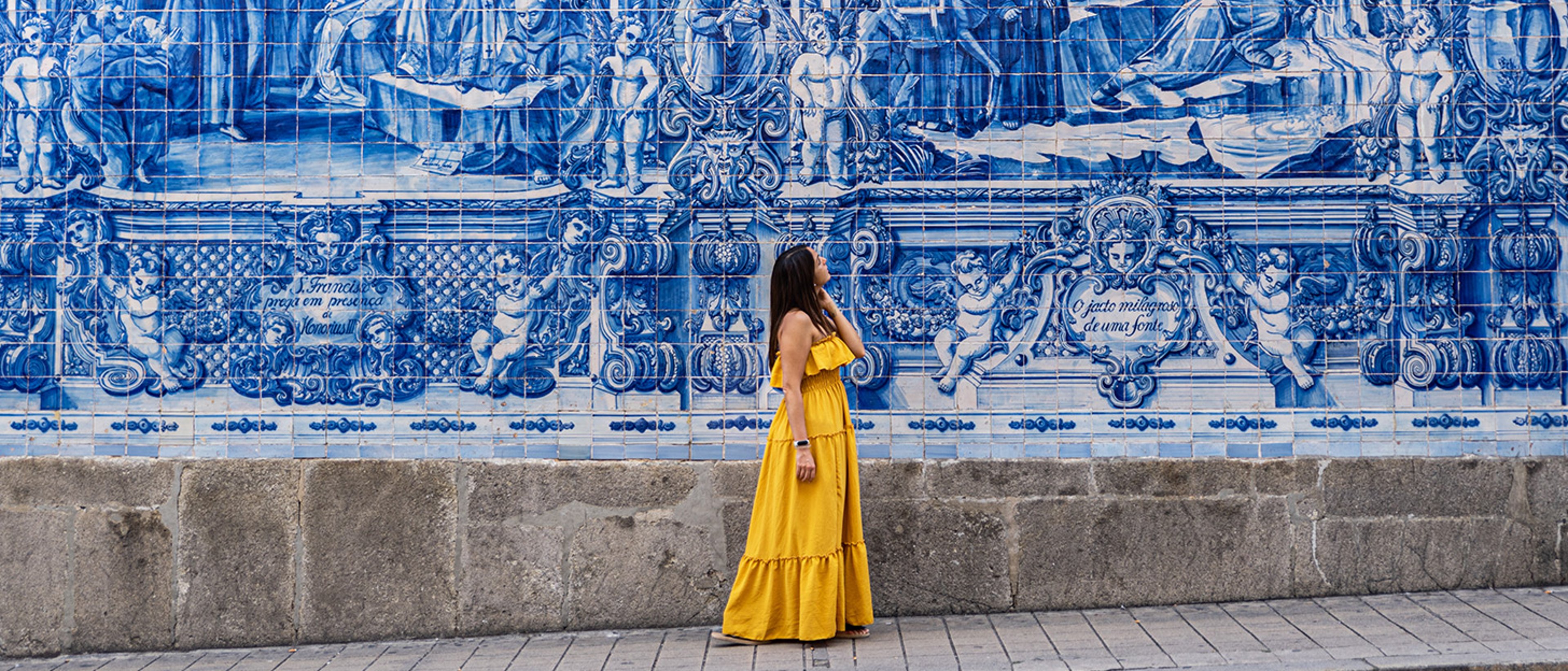 Woman viewing a decorative wall in Europe