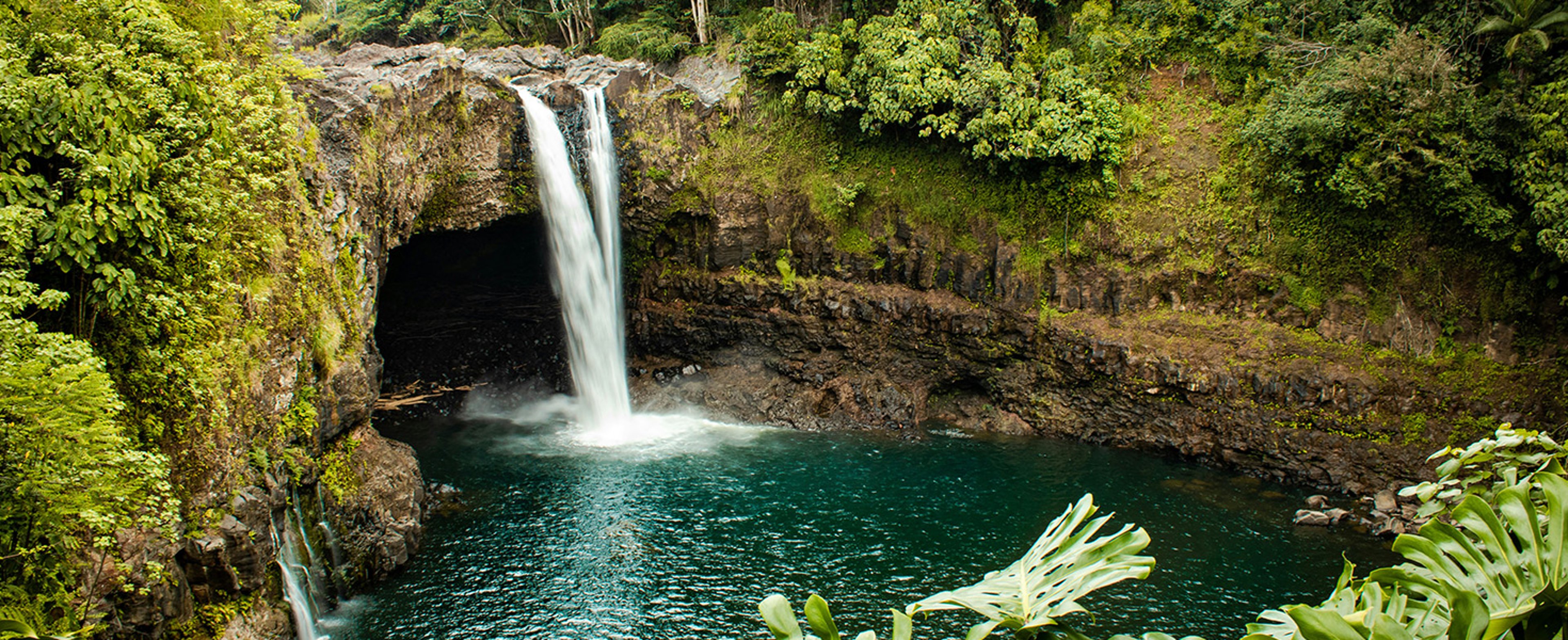 Rainbow Falls is an 80-foot waterfall located in Wailuku River State Park near Hilo on Hawaii's Big Island