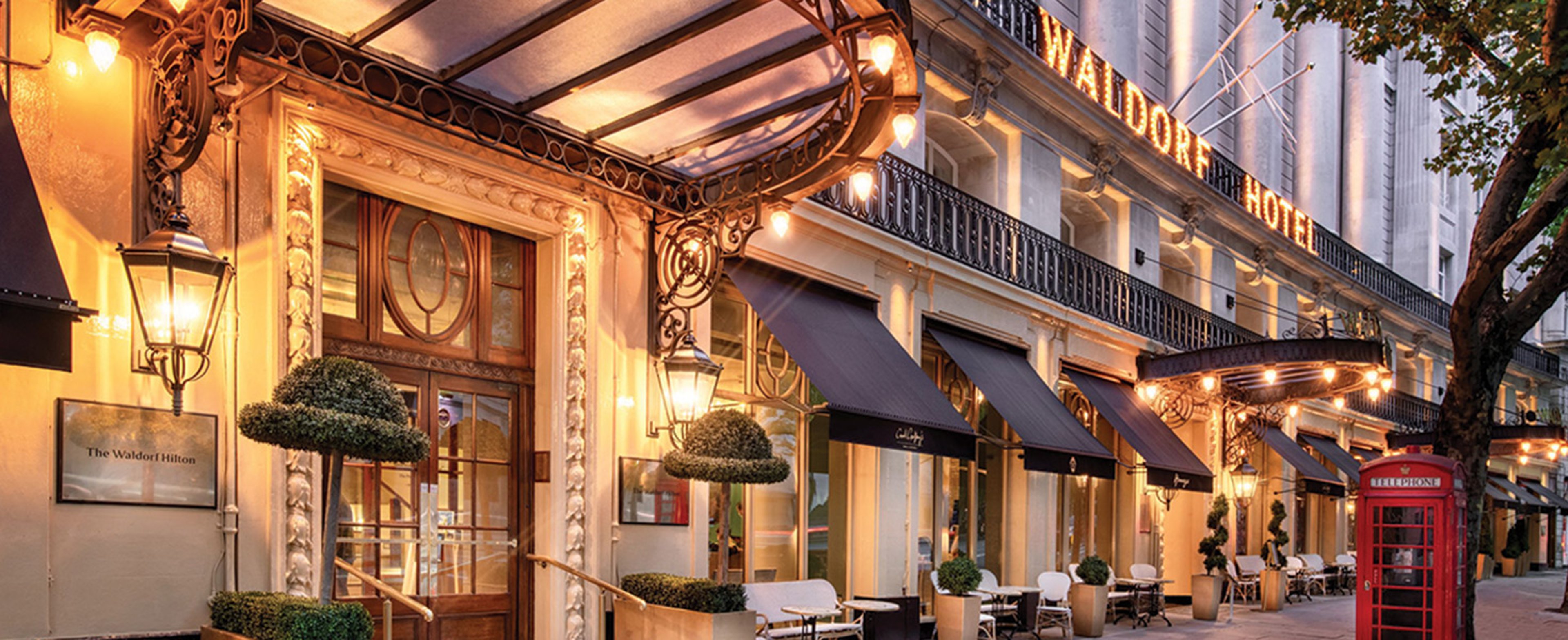 The image shows the historic exterior of The Waldorf Hilton, London, located on Aldwych in the Covent Garden area