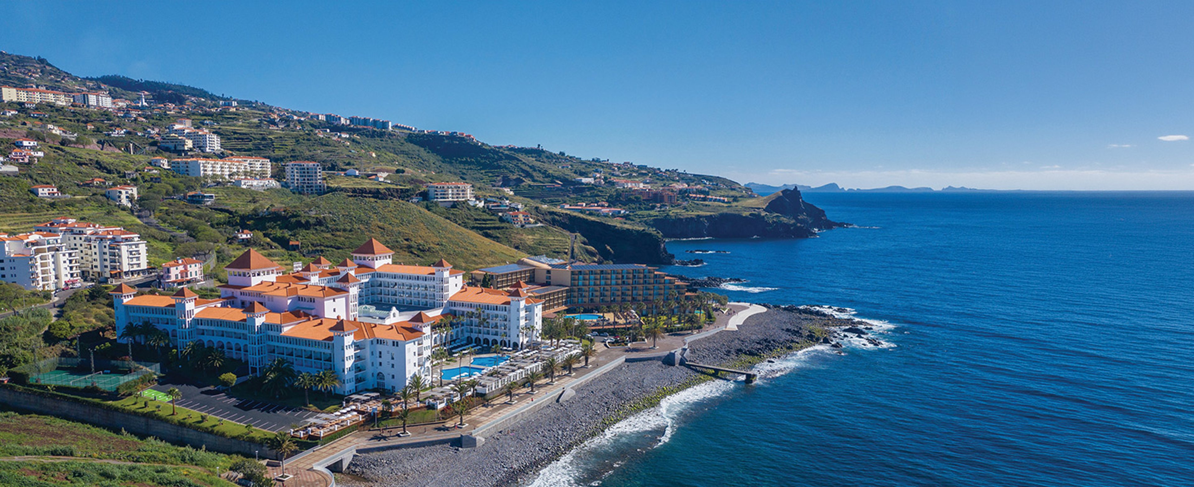 The image shows the Hotel Riu Madeira, a 4-star all-inclusive beach resort located on the southern coast of Madeira Island in Portugal