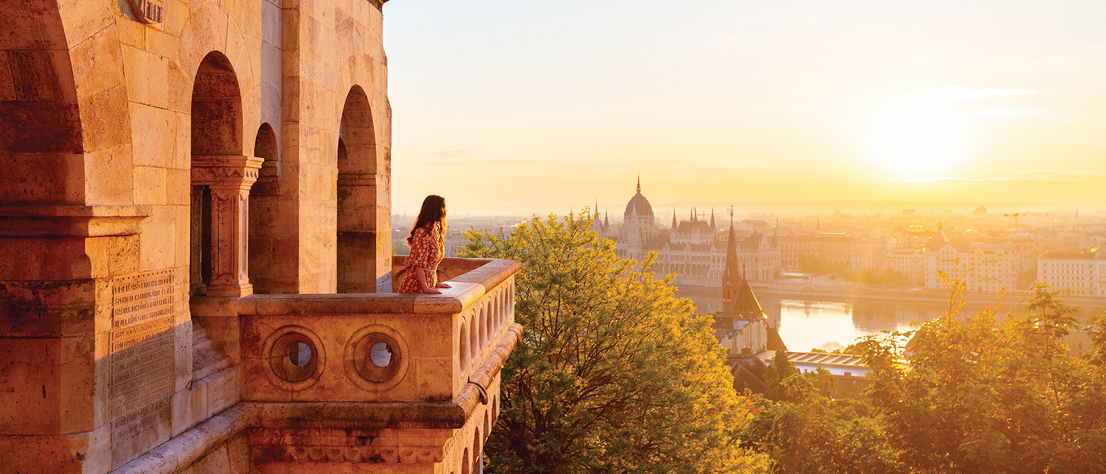 Woman on balcony overlooking scenery