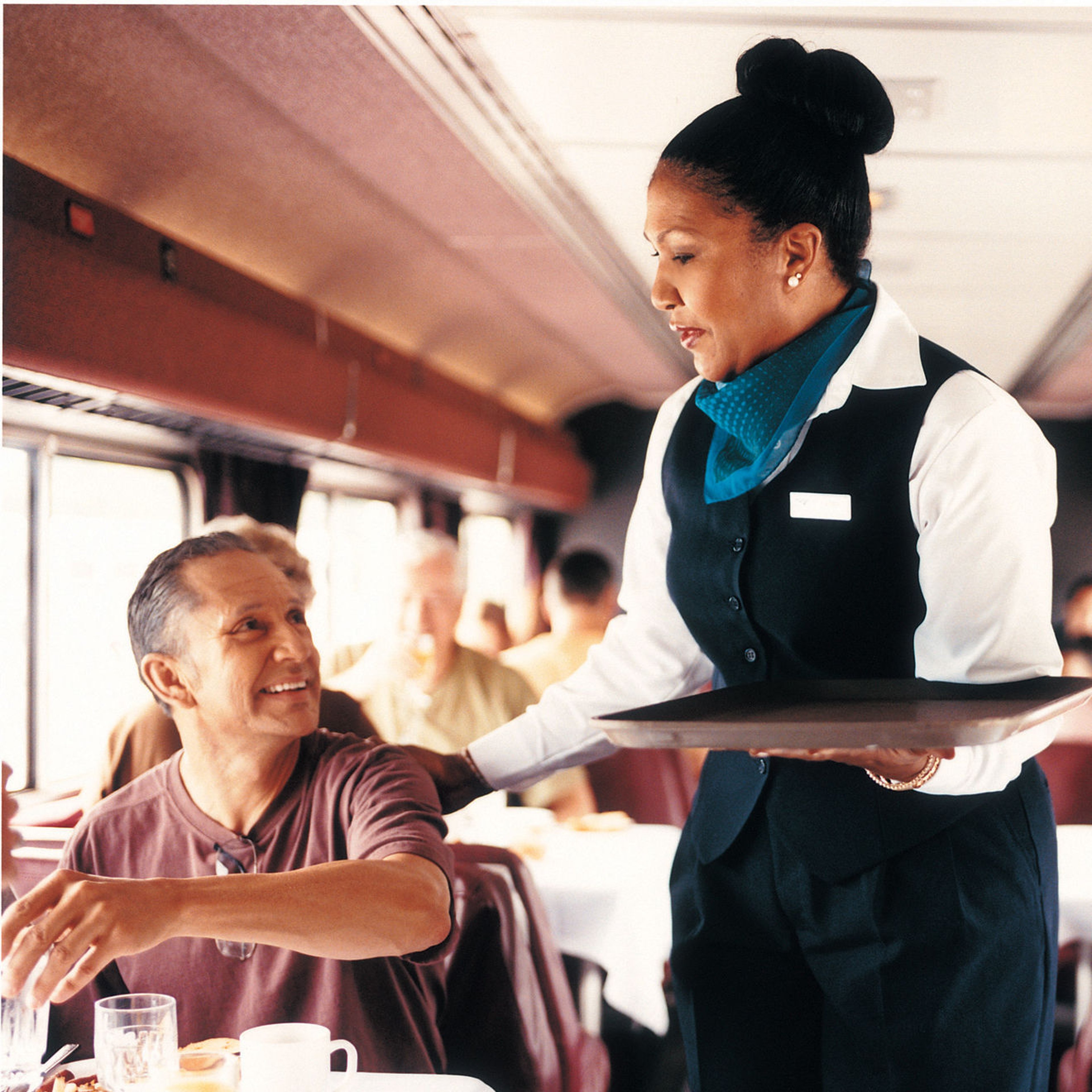 Amtrak service attendant taking order of smiling patron