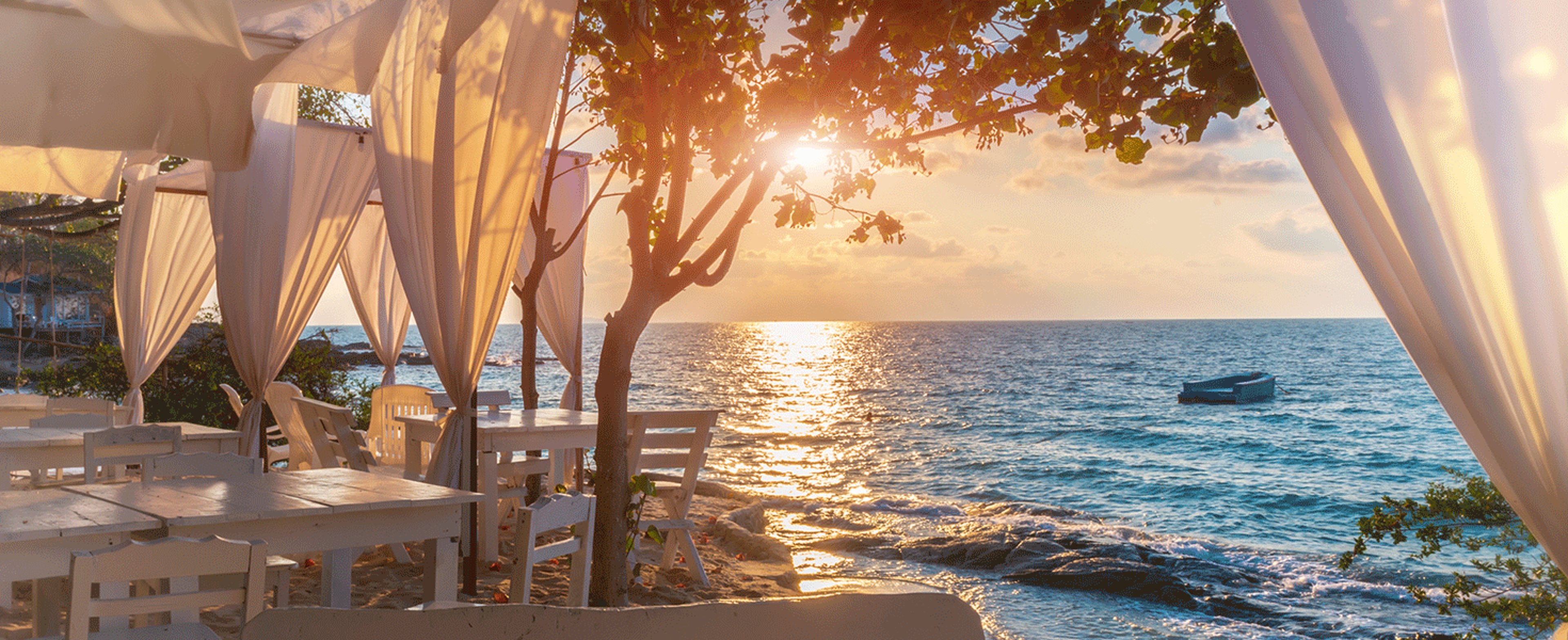 Beach cabanas looking out over sunset on the ocean