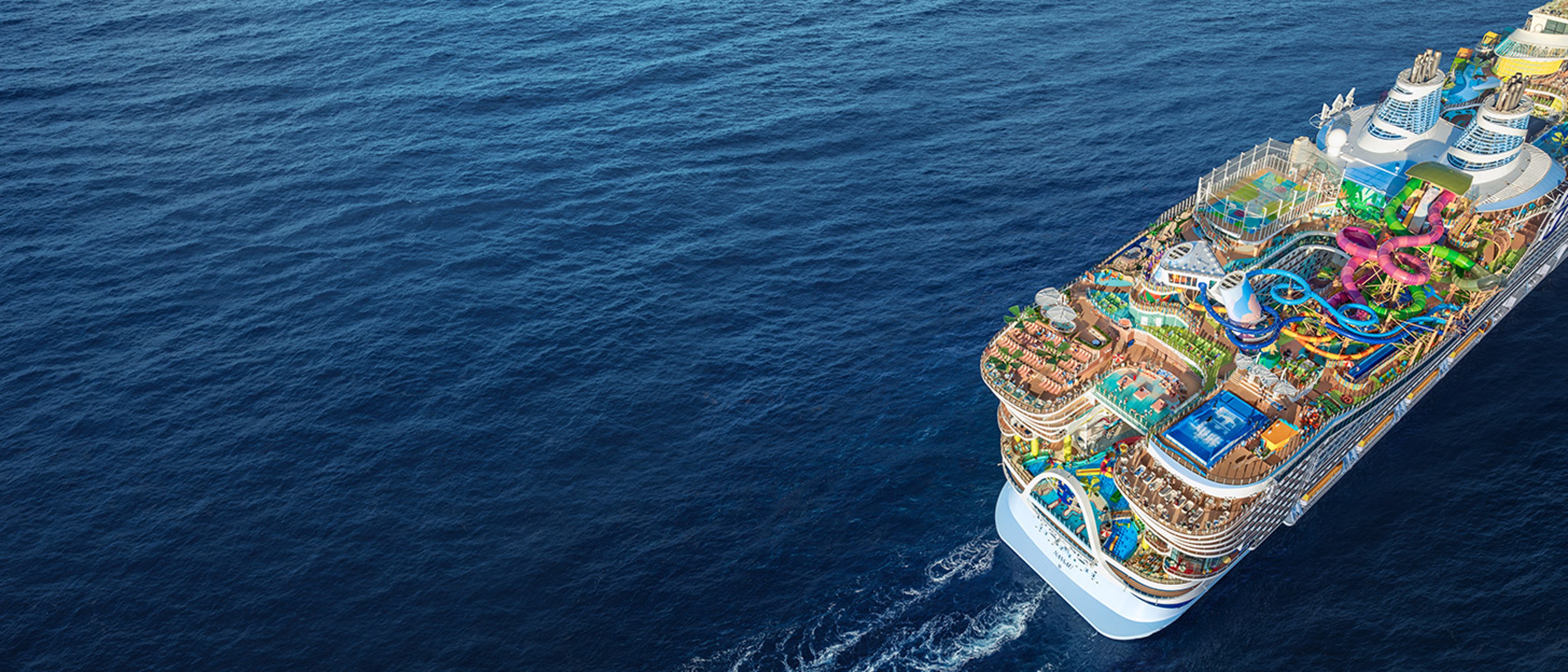 a Royal Caribbean Icon Class cruise ship, captured from an aerial perspective while navigating open water.