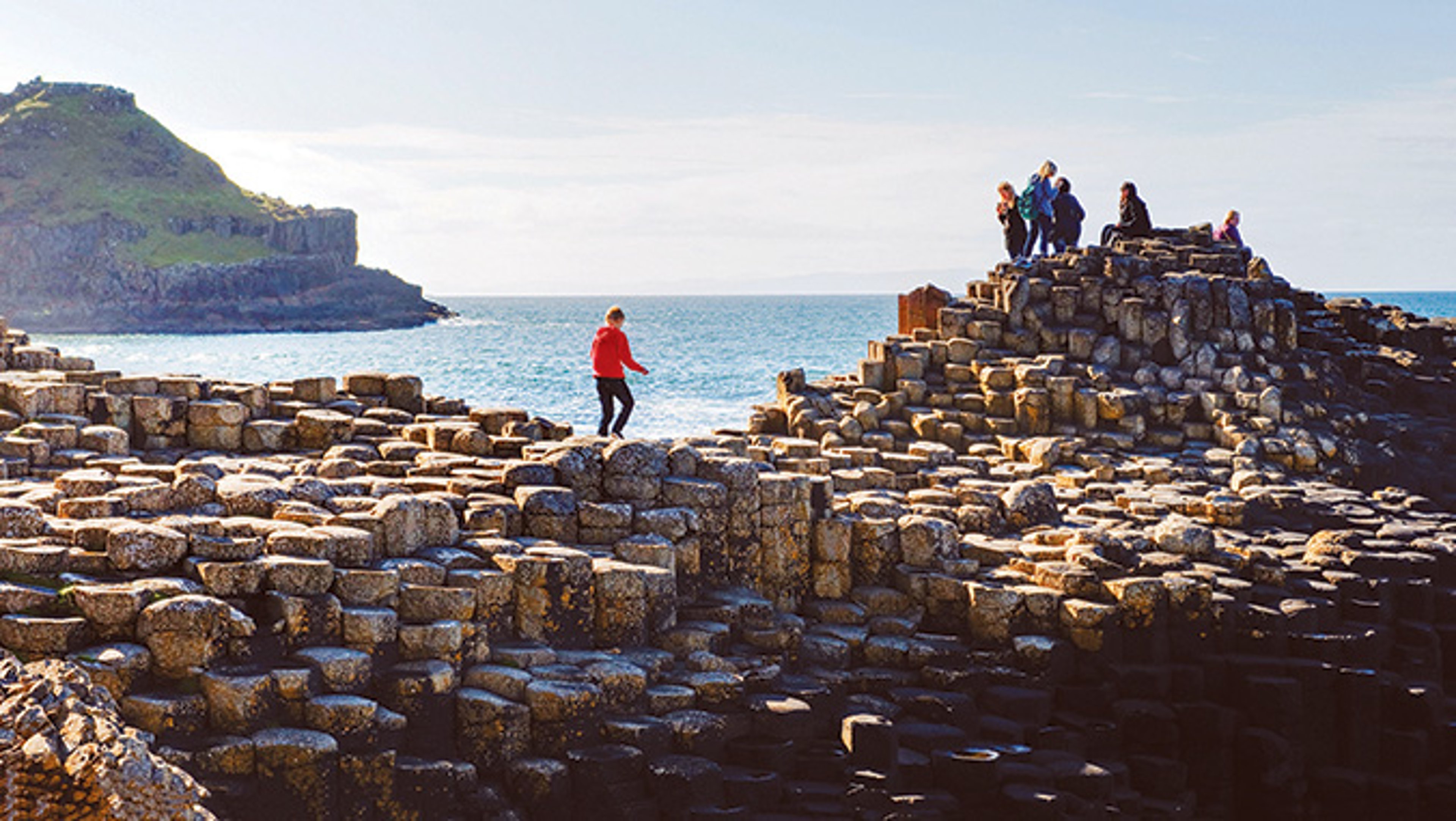 A tourist explores Giant's Causeway in Northern Ireland