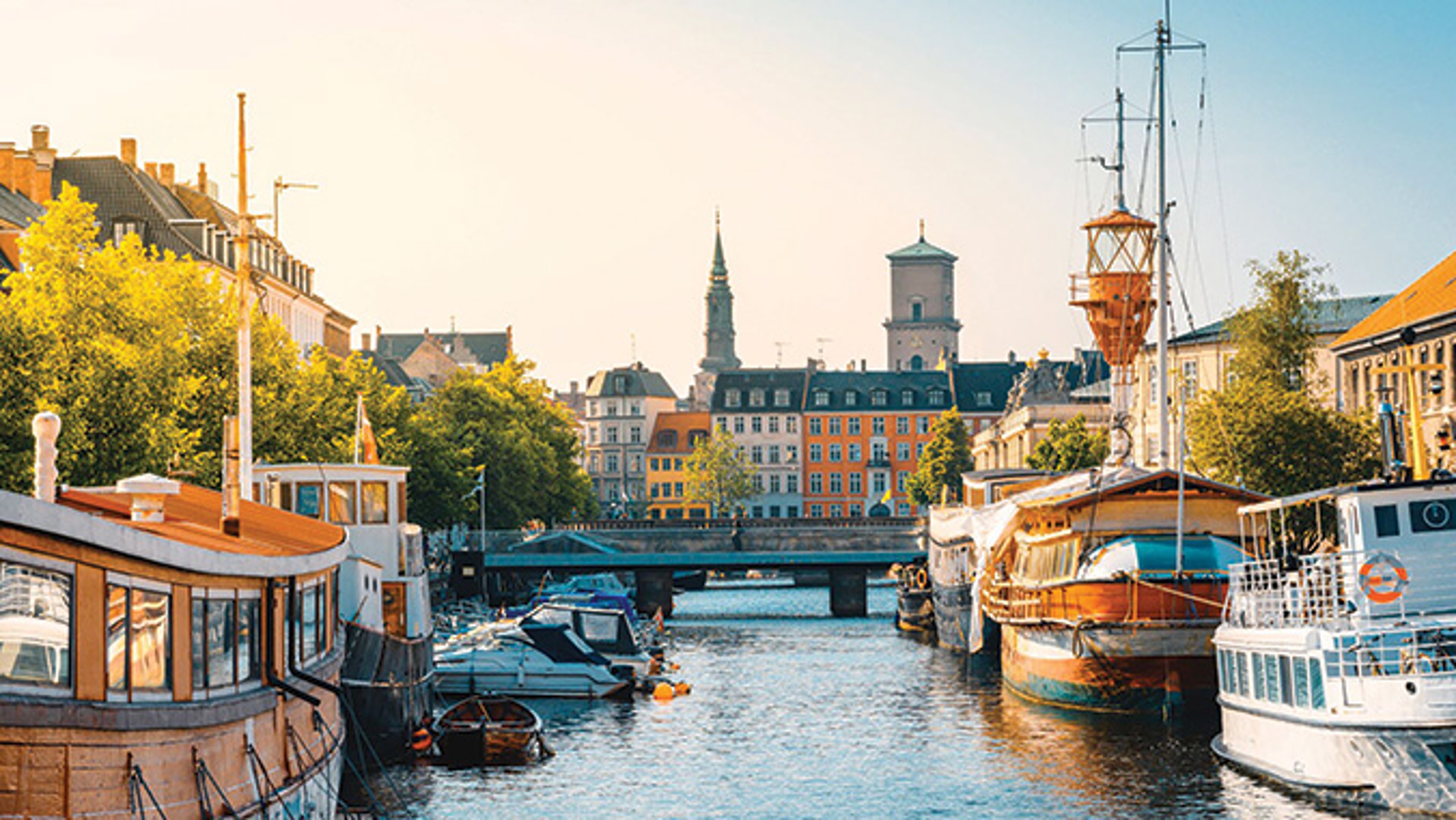 View of Copenhagen, Denmark with canal and picturesque buildings.