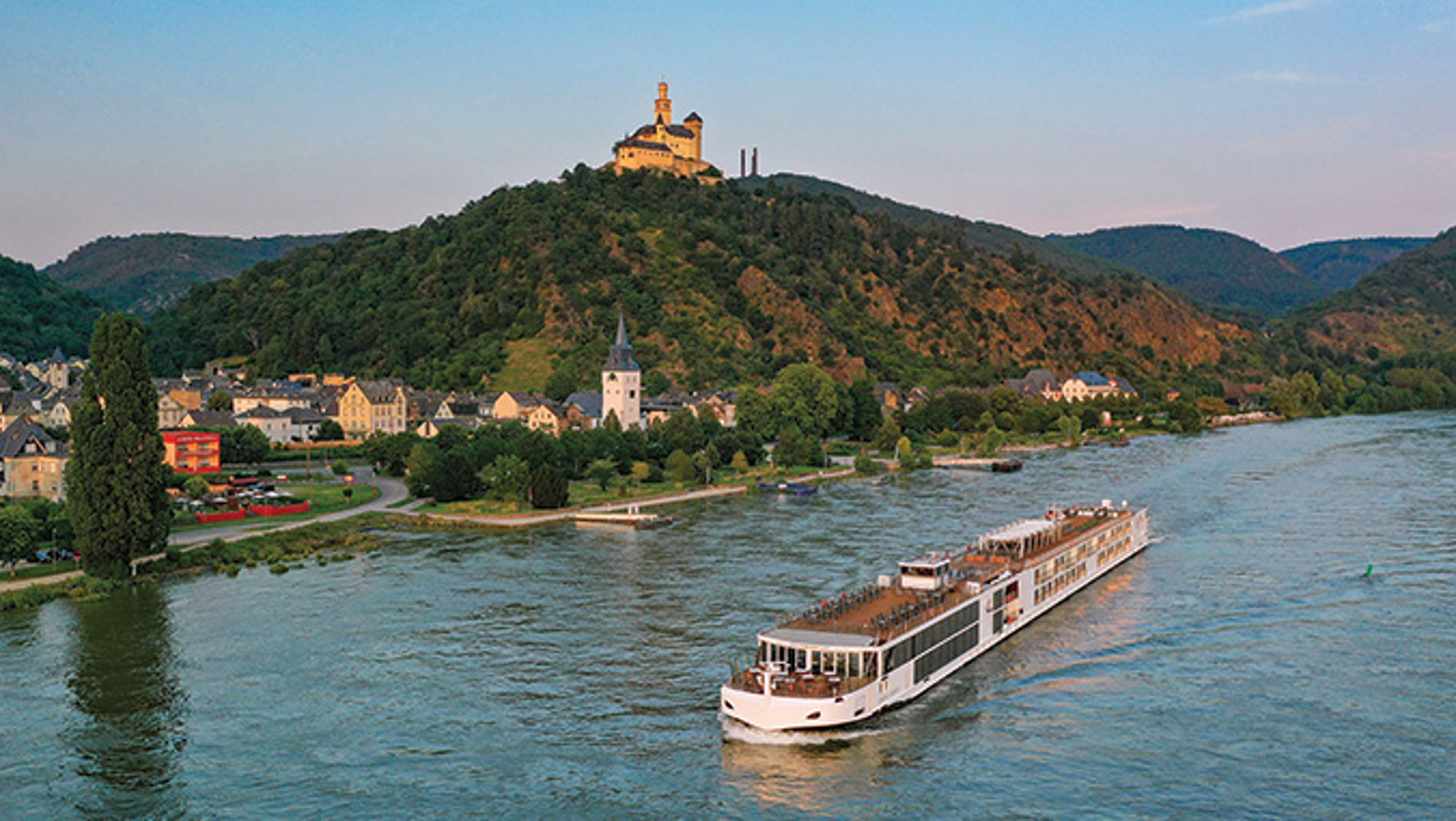 Viking cruise ship sails the Rhine river with castle in background