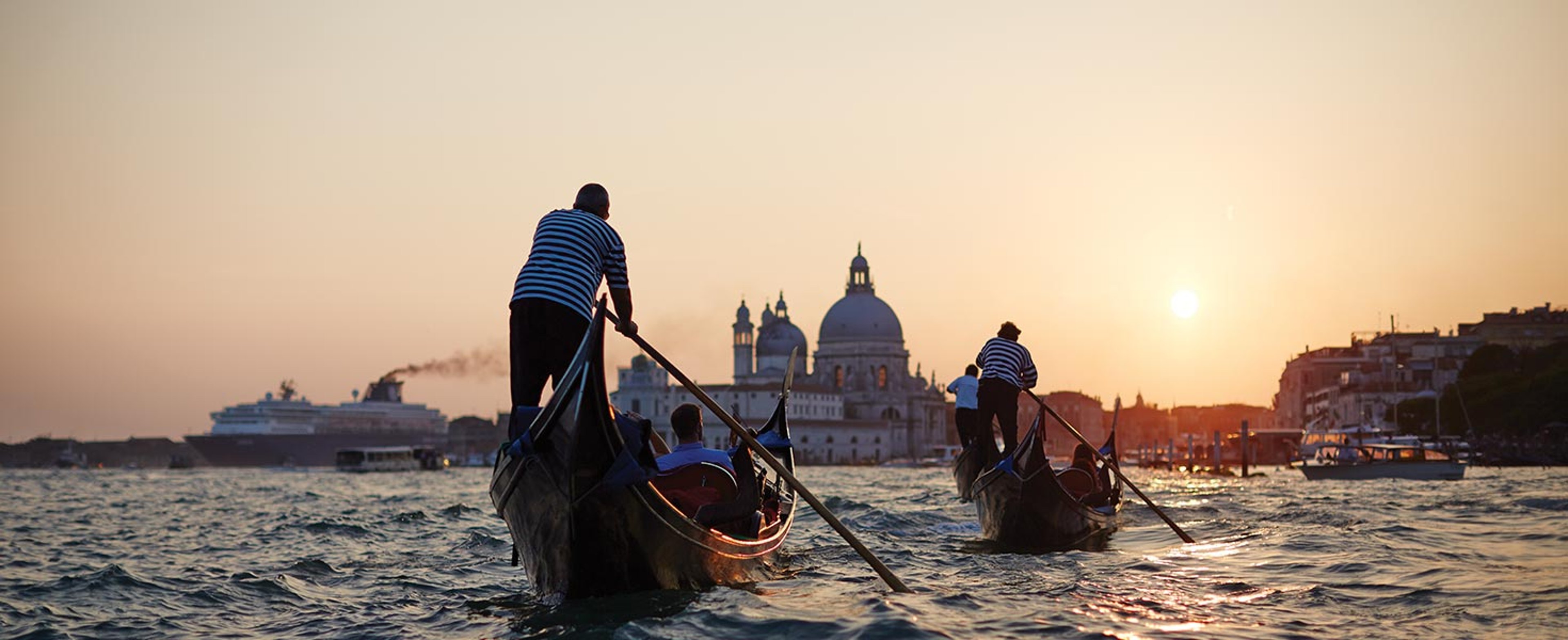 Two gondolas sailing through Venice waterways