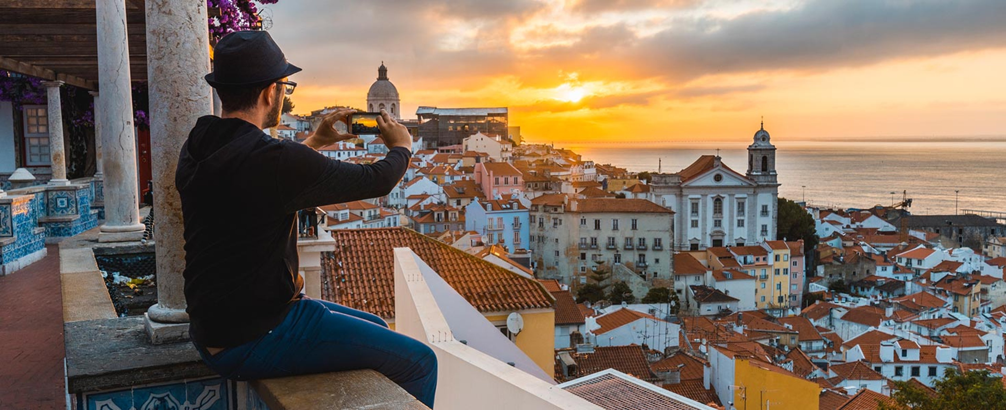 Man taking photo of city in portugal
