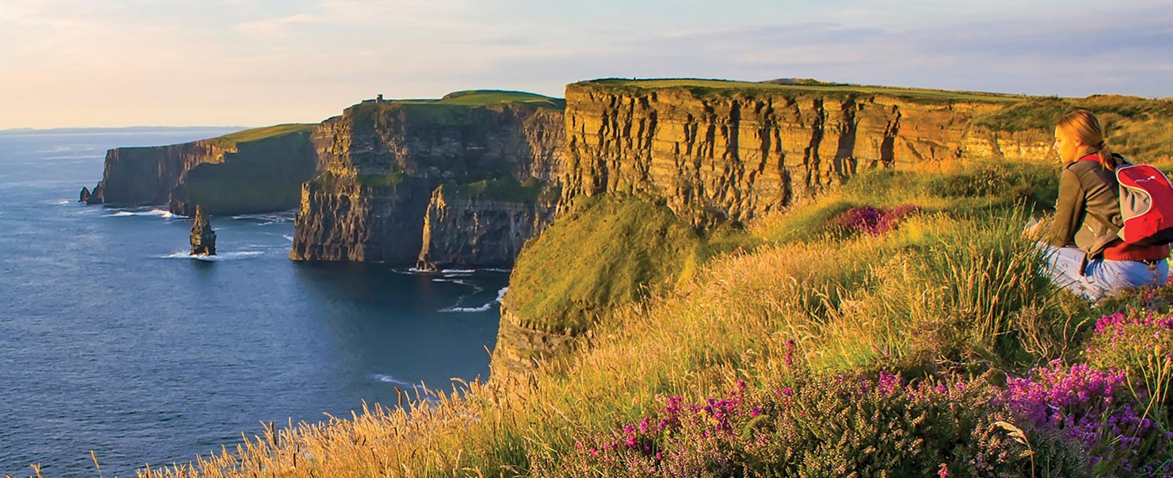 Woman overlooking the Cliffs of Moher