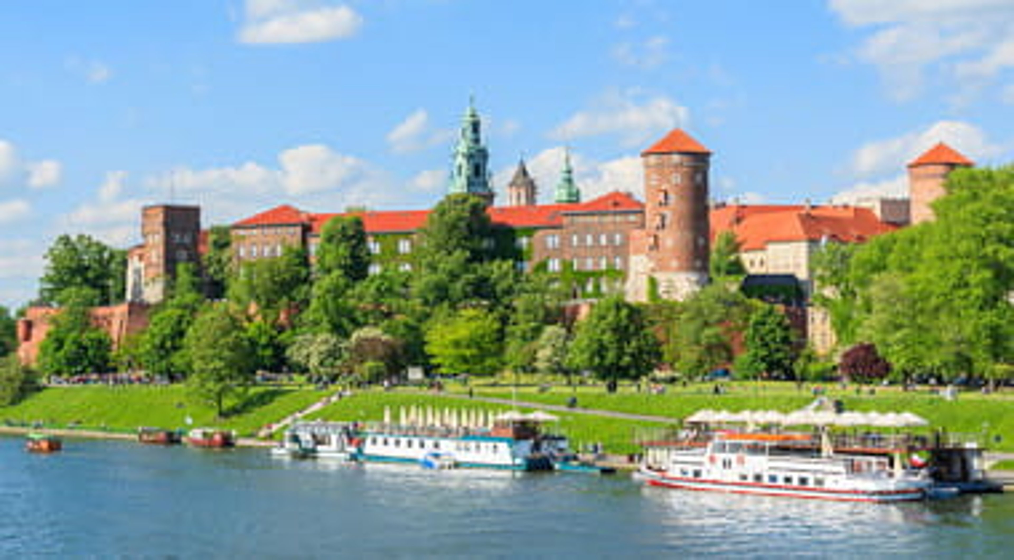 Tourist boats on the river near royal castle