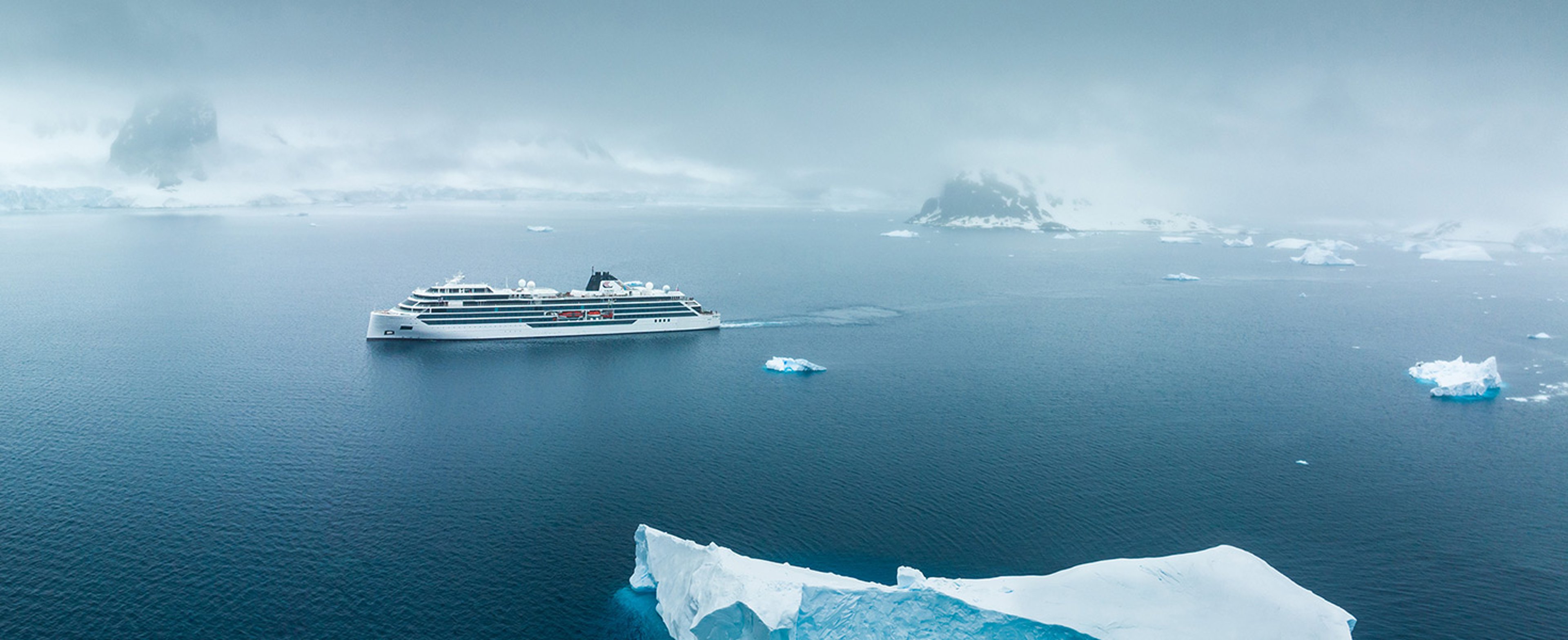 A Viking Expedition ship cruising through the iceberg dotted waters in Antarctica 