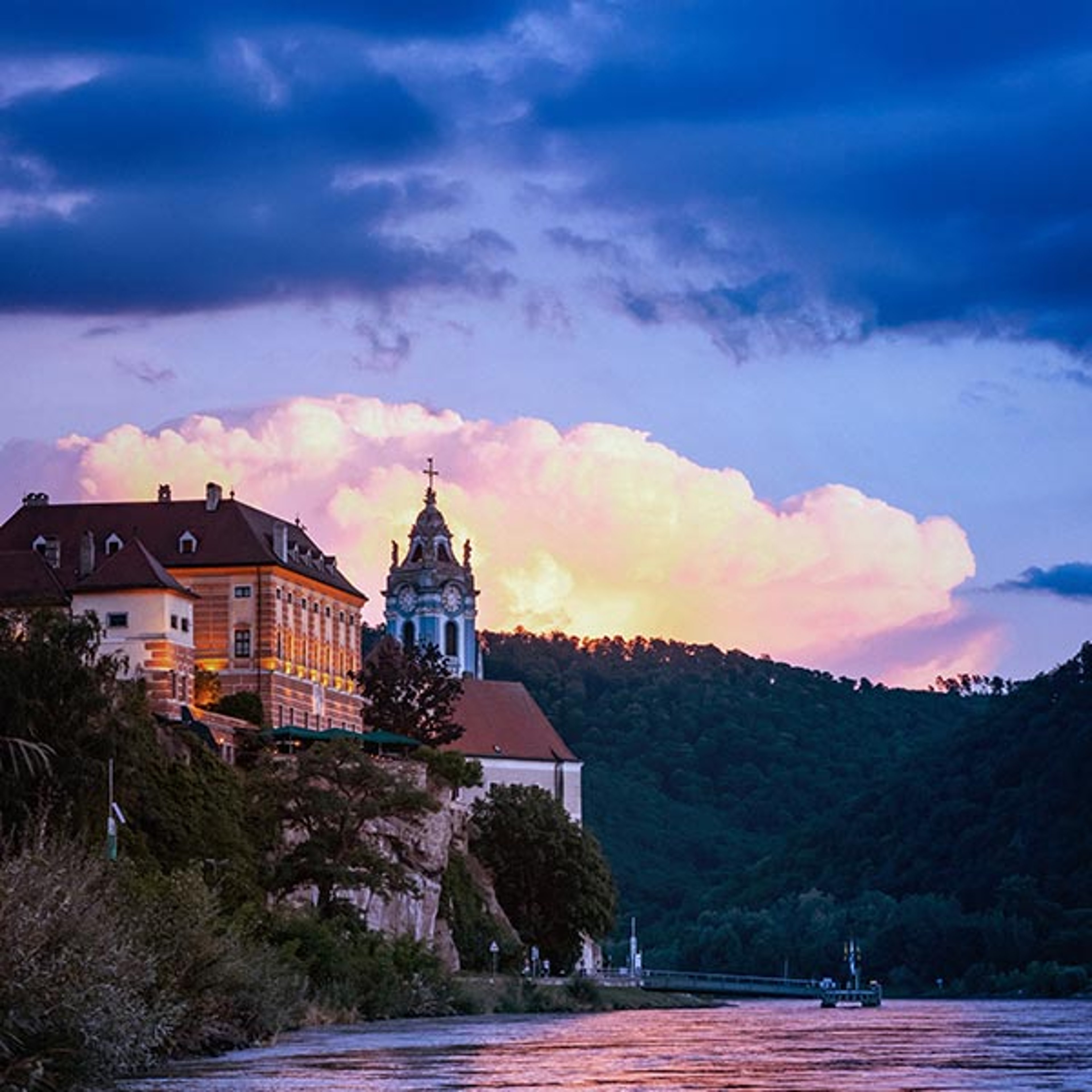 The image appears to show the blue tower of the Dürnstein Abbey along the Danube River in the Wachau Valley of Lower Austria
