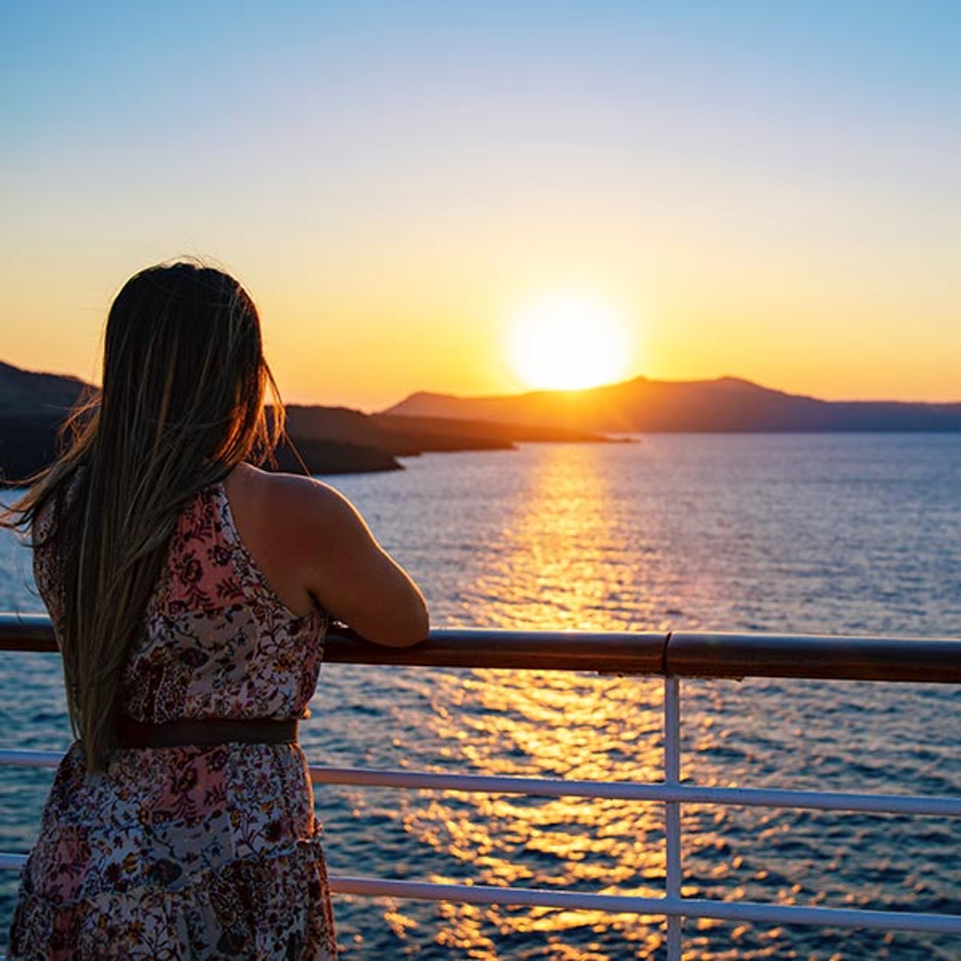 Woman at rail of Azamara ship in Santorini