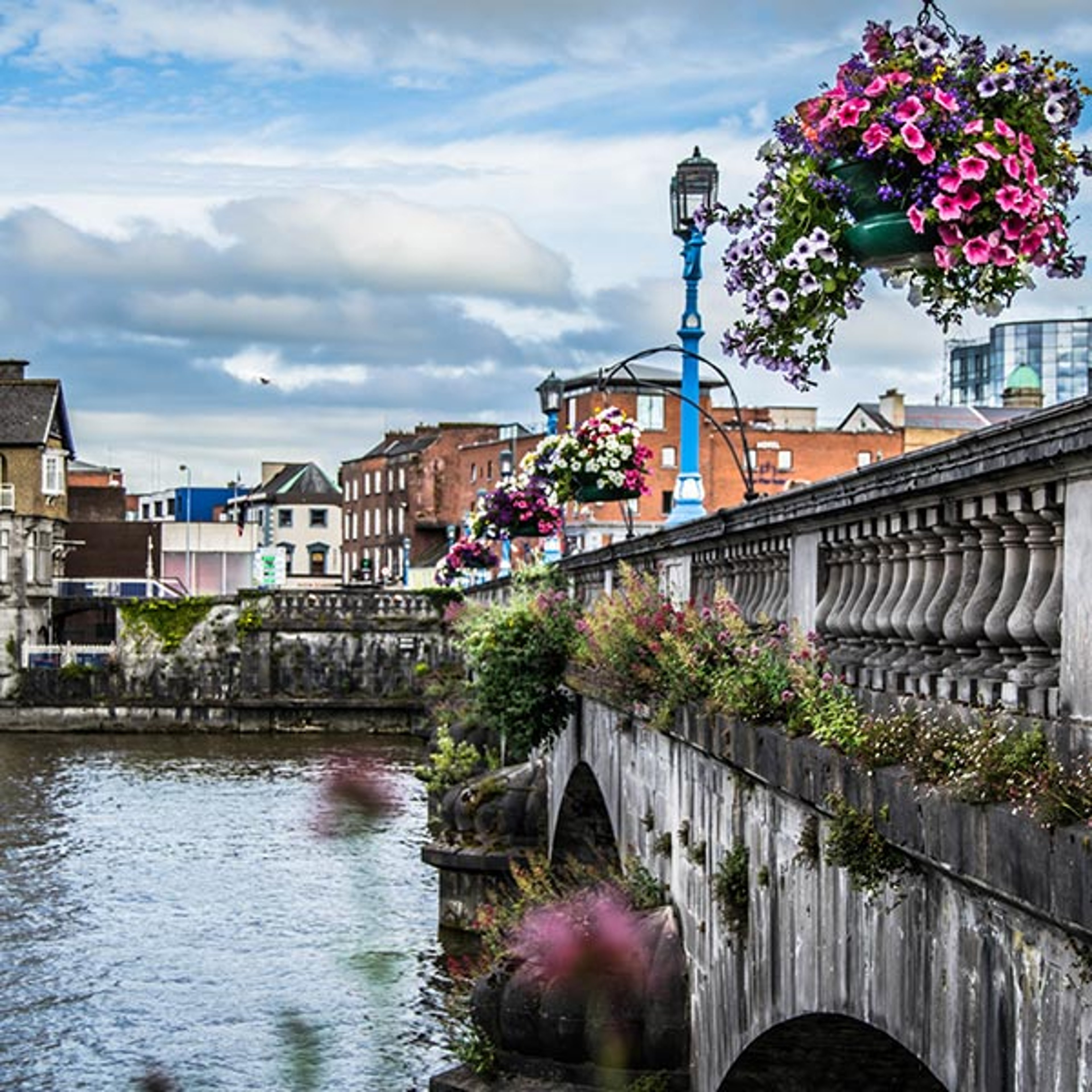 The image appears to show the scenic Garvoge River flowing through Sligo town in County Sligo, Ireland
