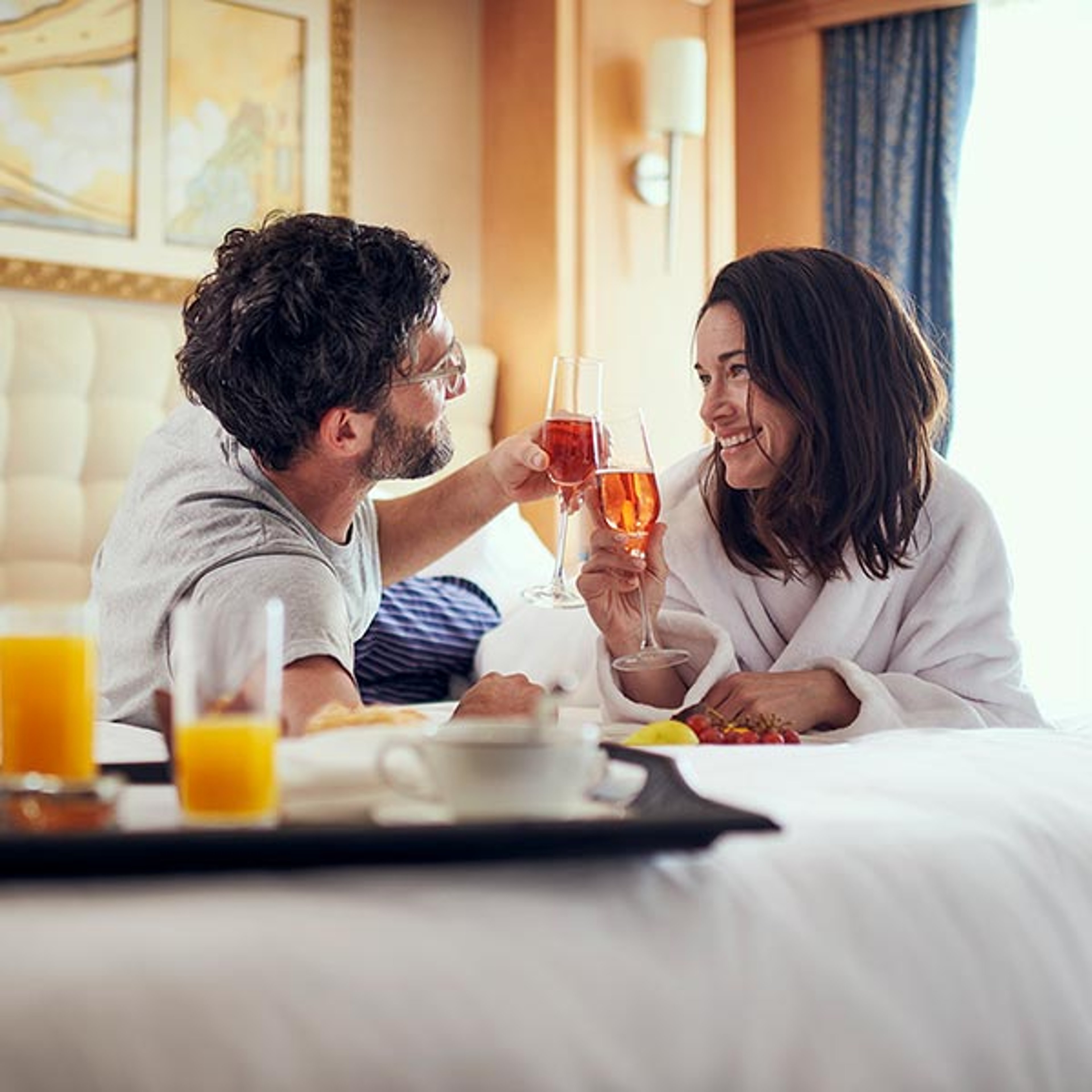 Couple enjoying a room service meal in their Cunard stateroom