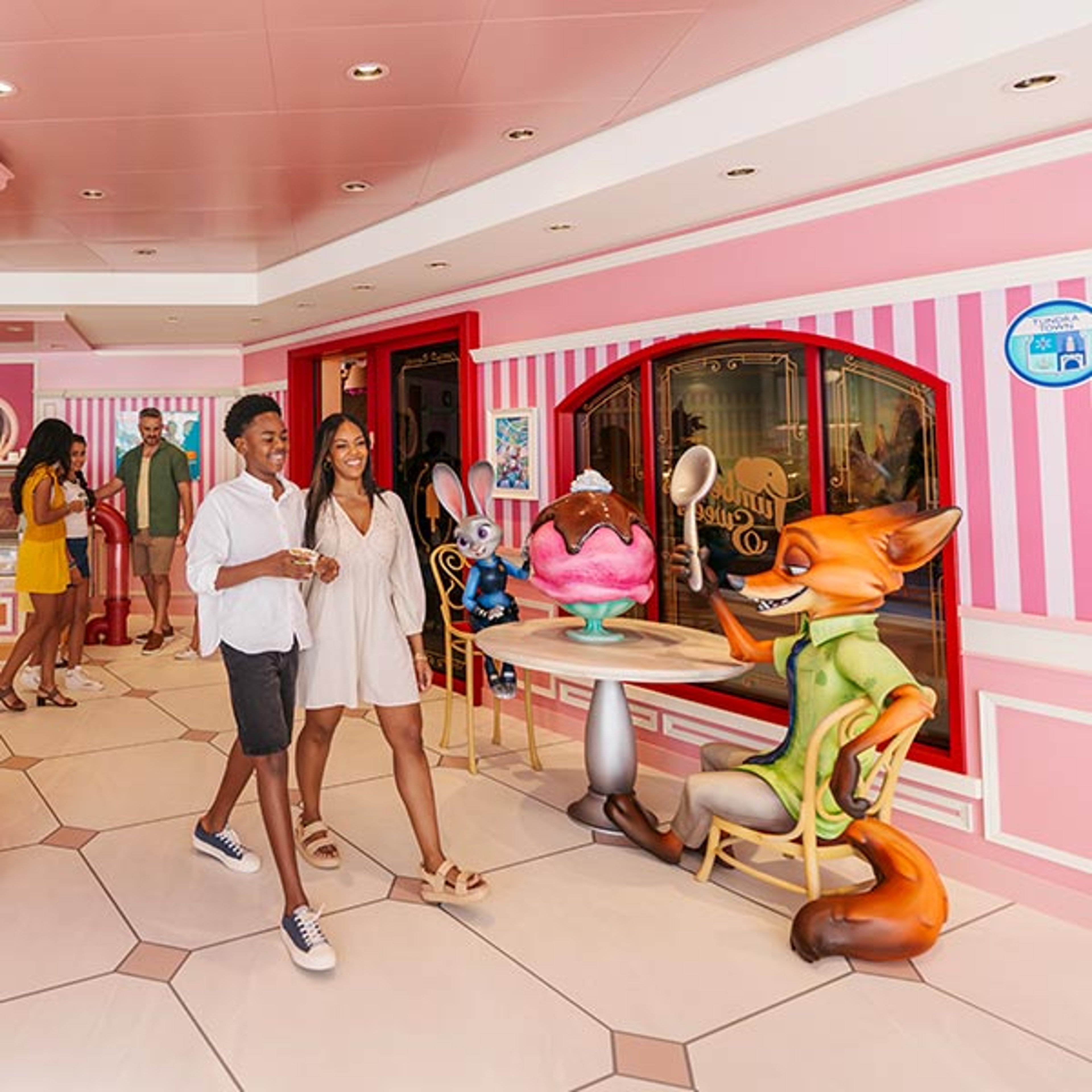 Couple walking by Disney Cruise onboard sweet shop with Zootopia characters nearby