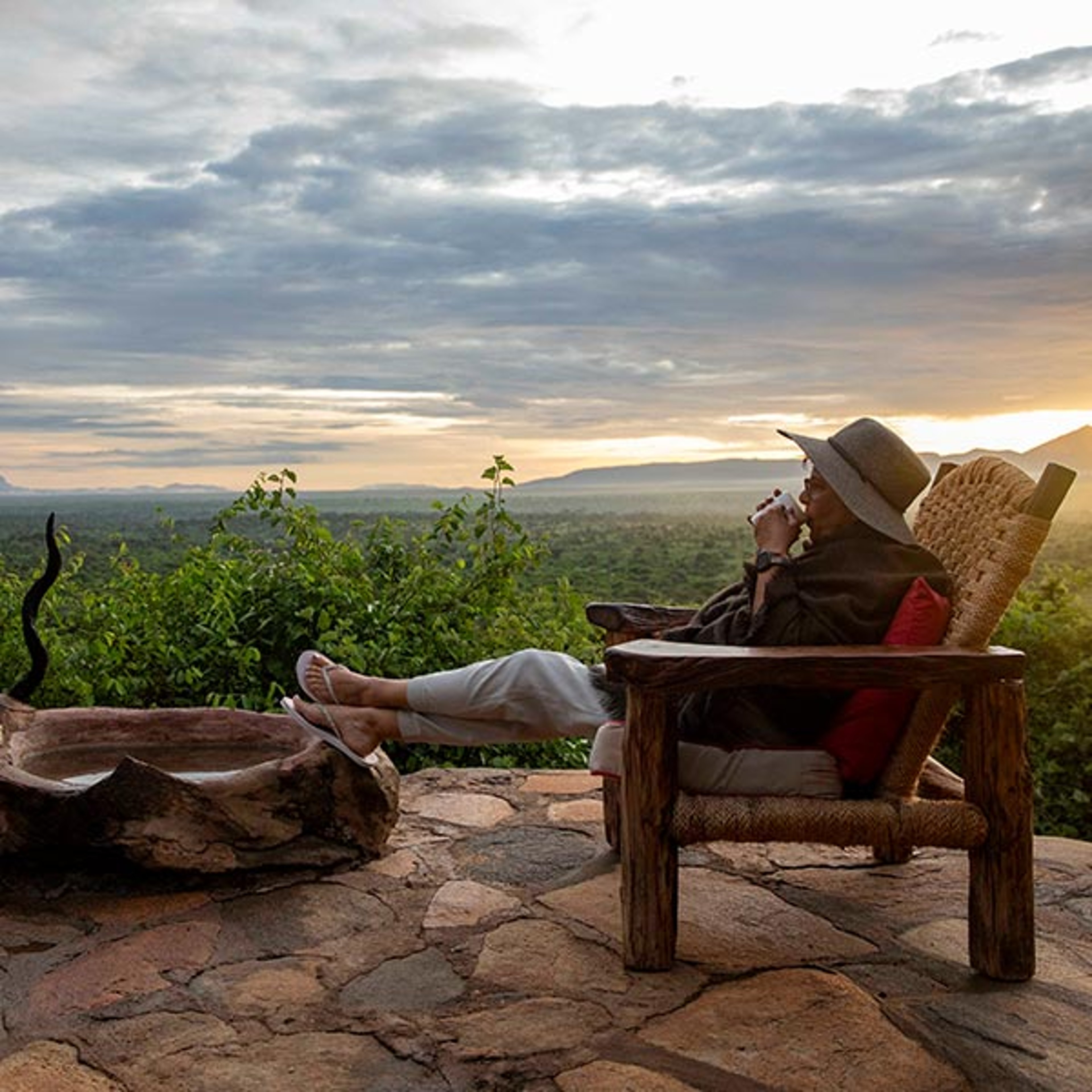Visitor to Africa drinking coffee while enjoying scenery