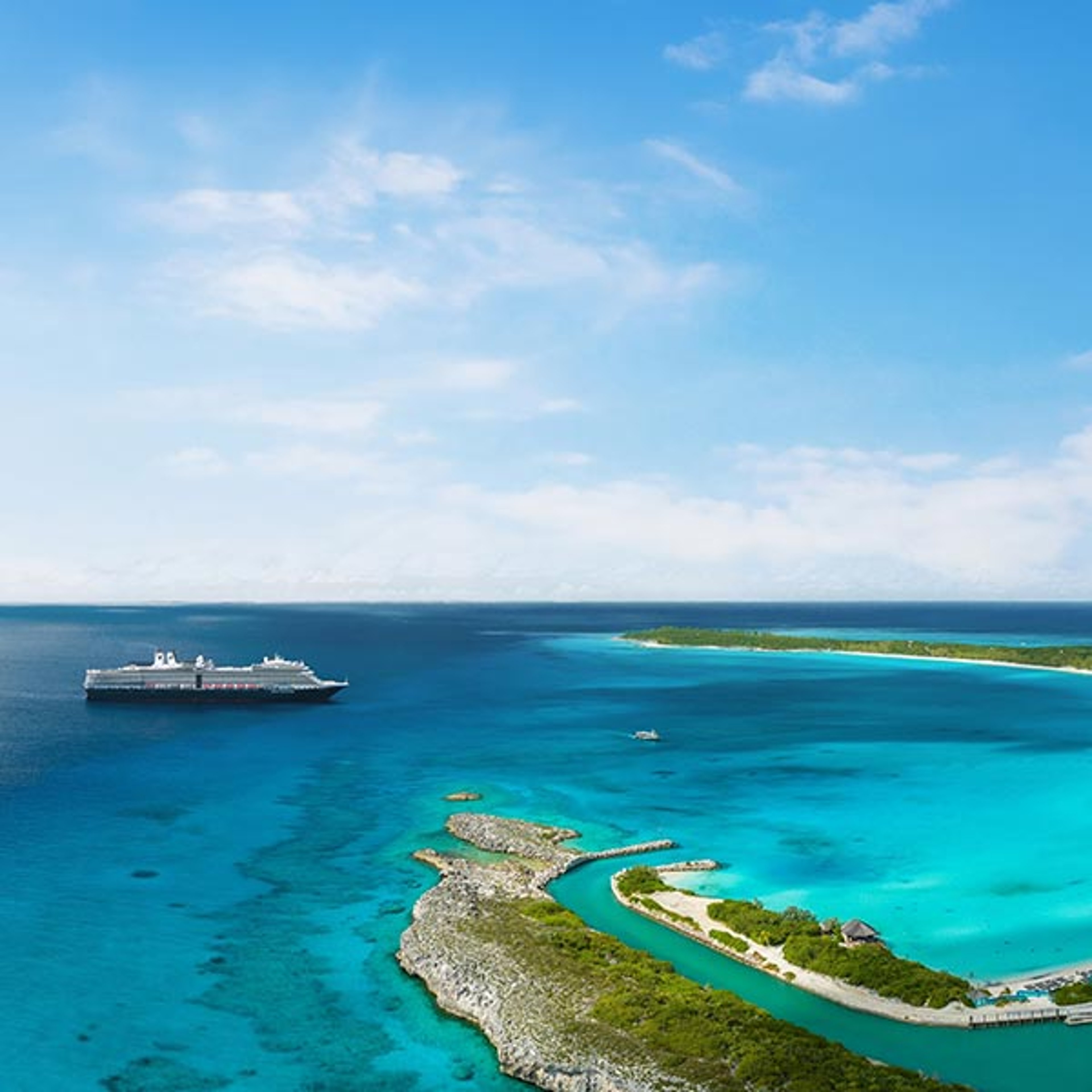 A Holland America ship docked off the shore of their private island Half Moon Cay