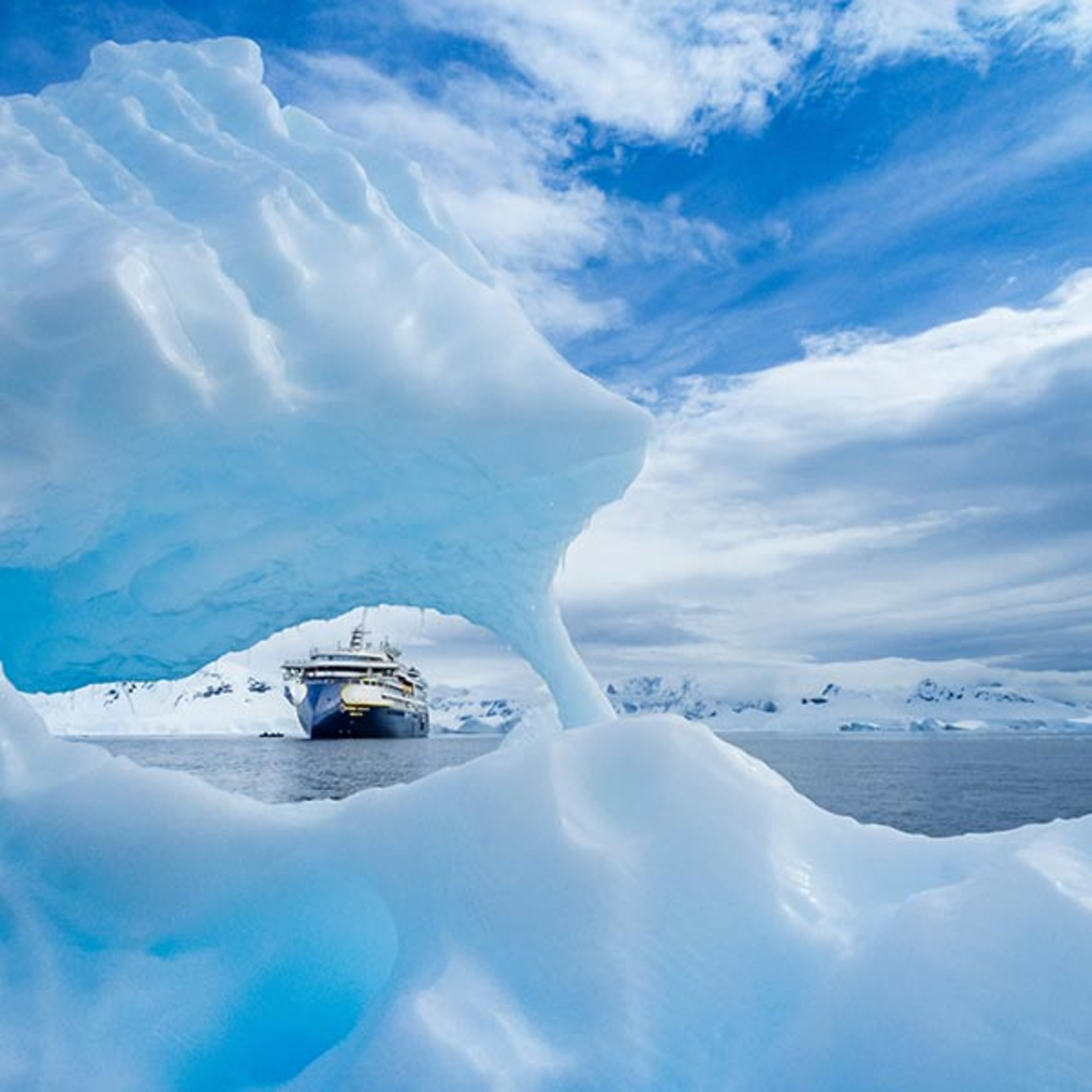 Lindblad ship traversing through glacier dotted waters