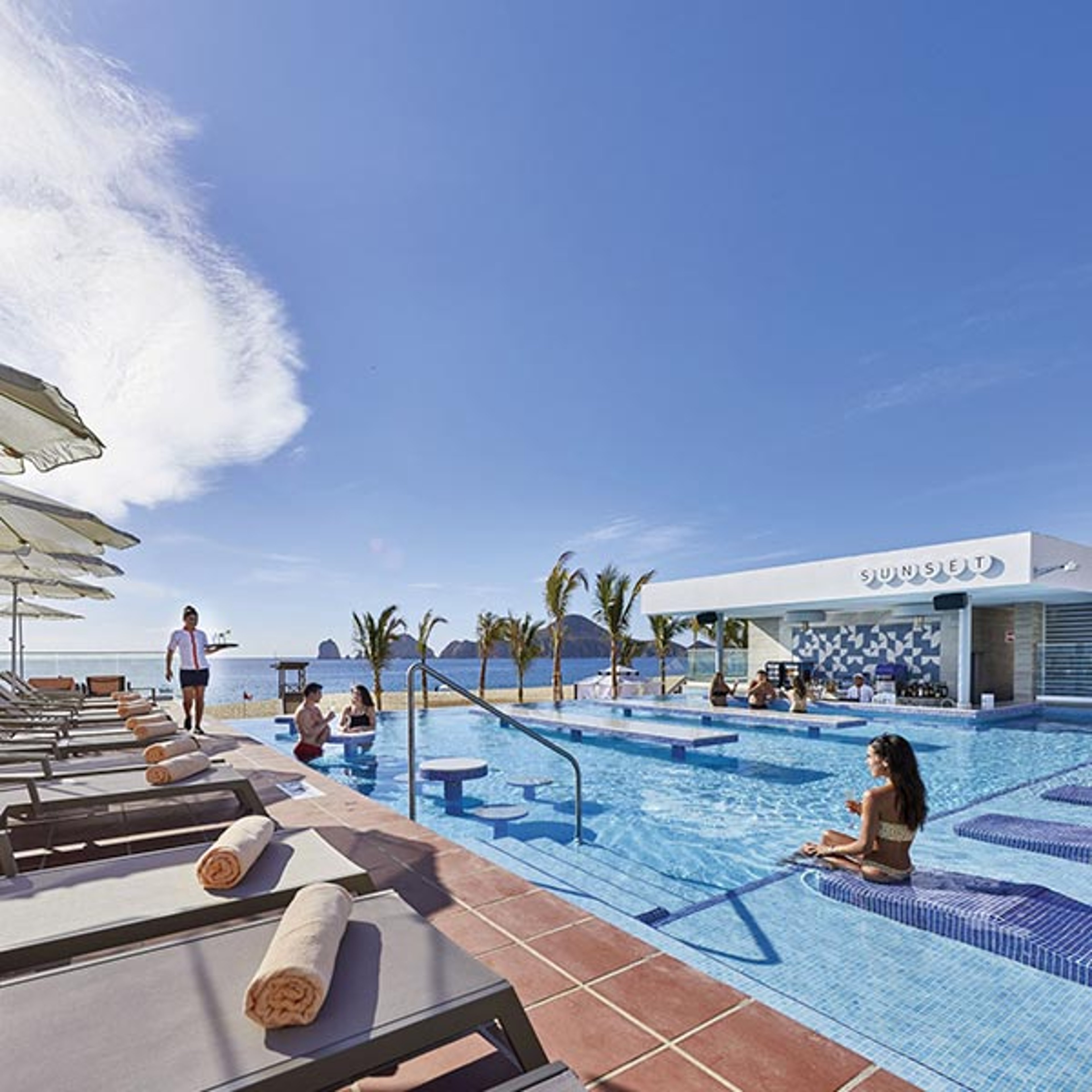 Vacationers at the pool at RIU Palace Baja