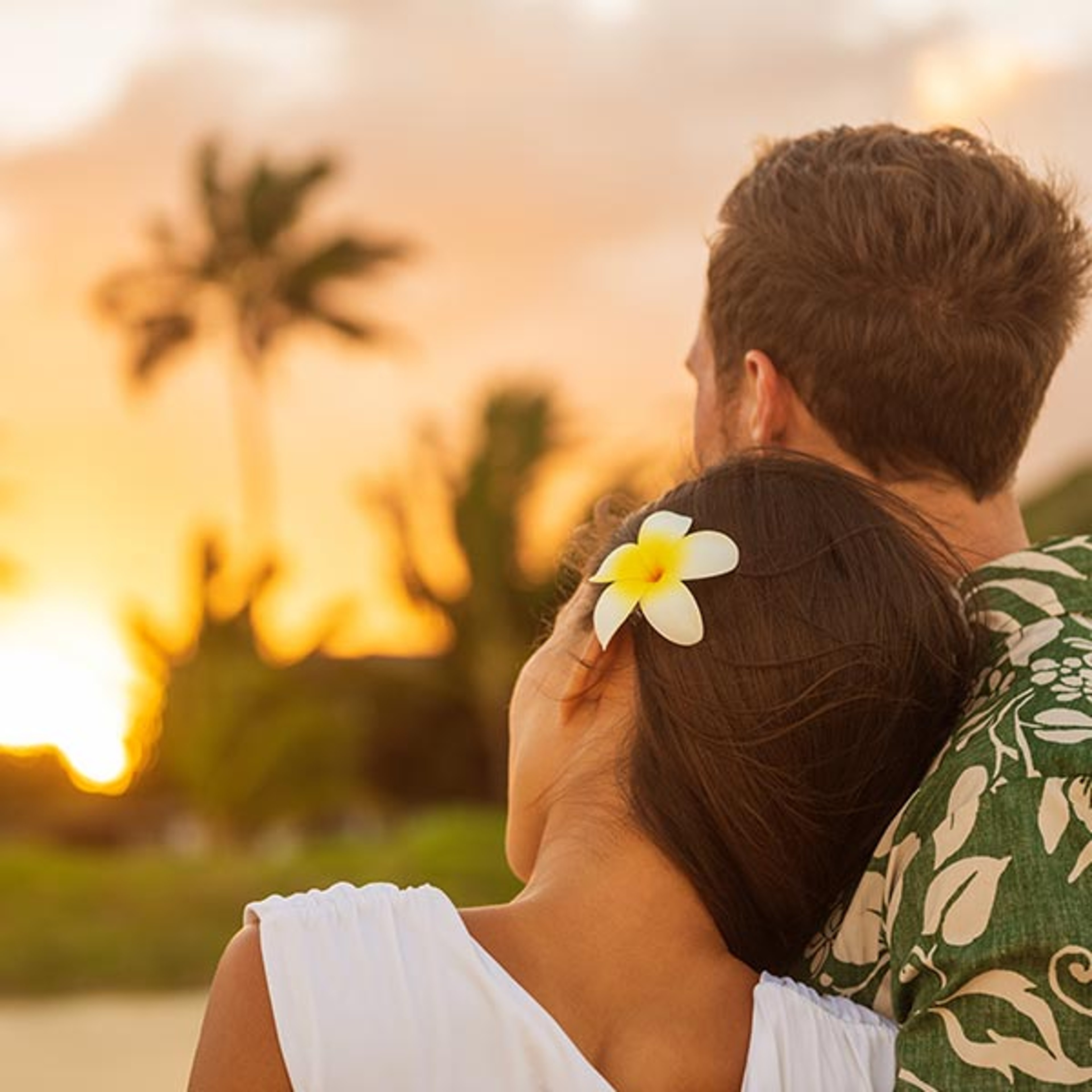 Couple enjoying sunset on a Hawaii beach