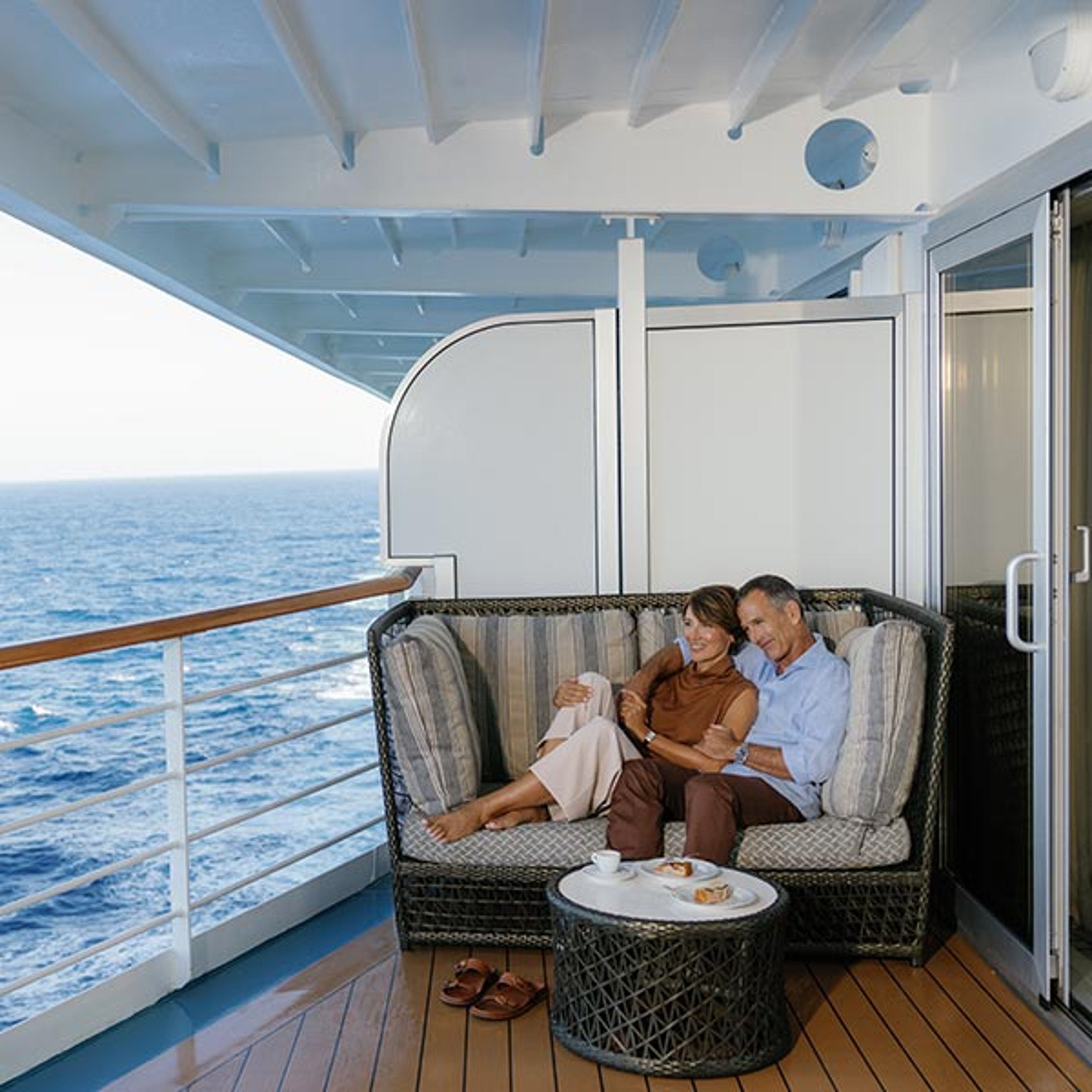 Couple enjoying the view from their Regent Seven Seas verandah