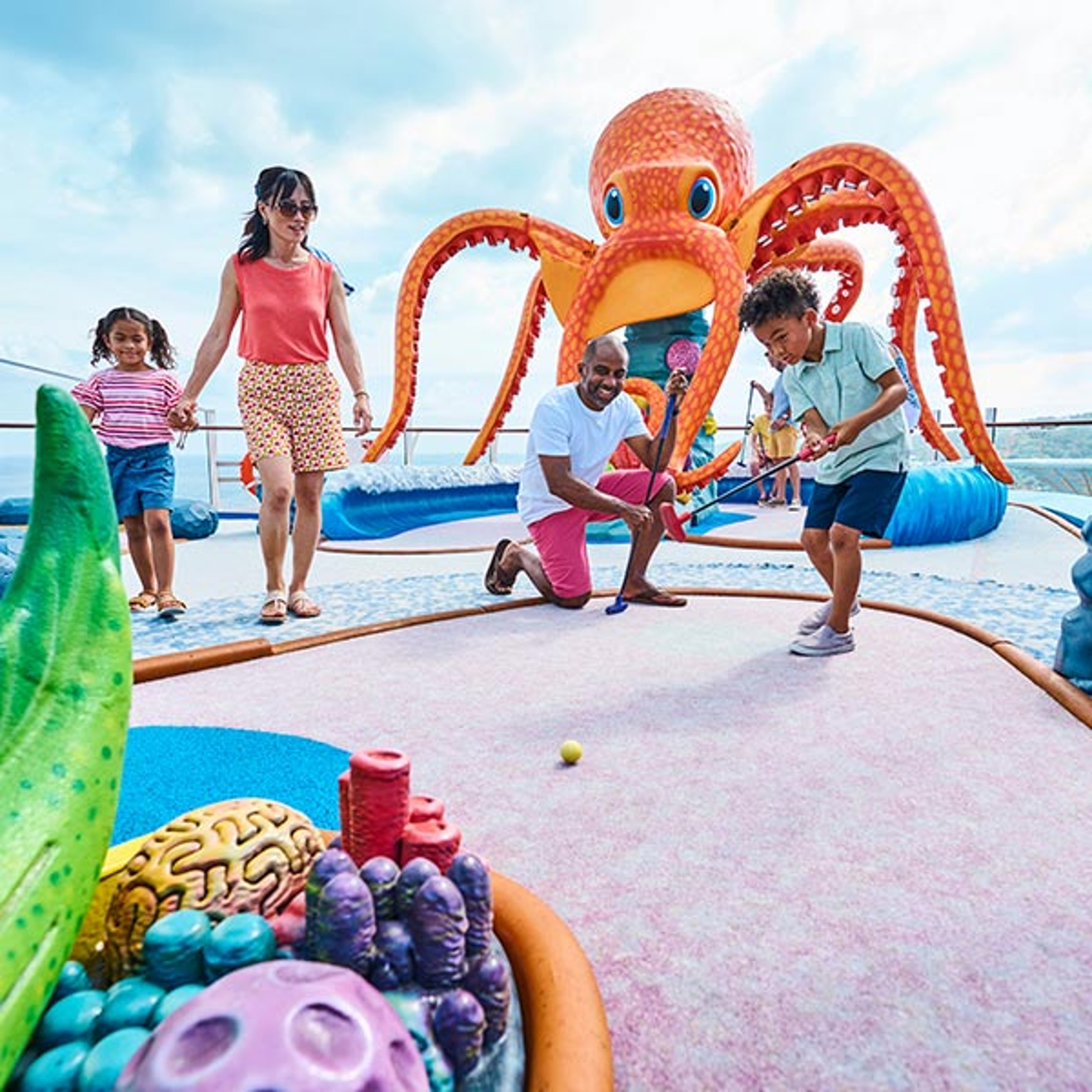 Family playing mini golf on Royal Caribbean ship